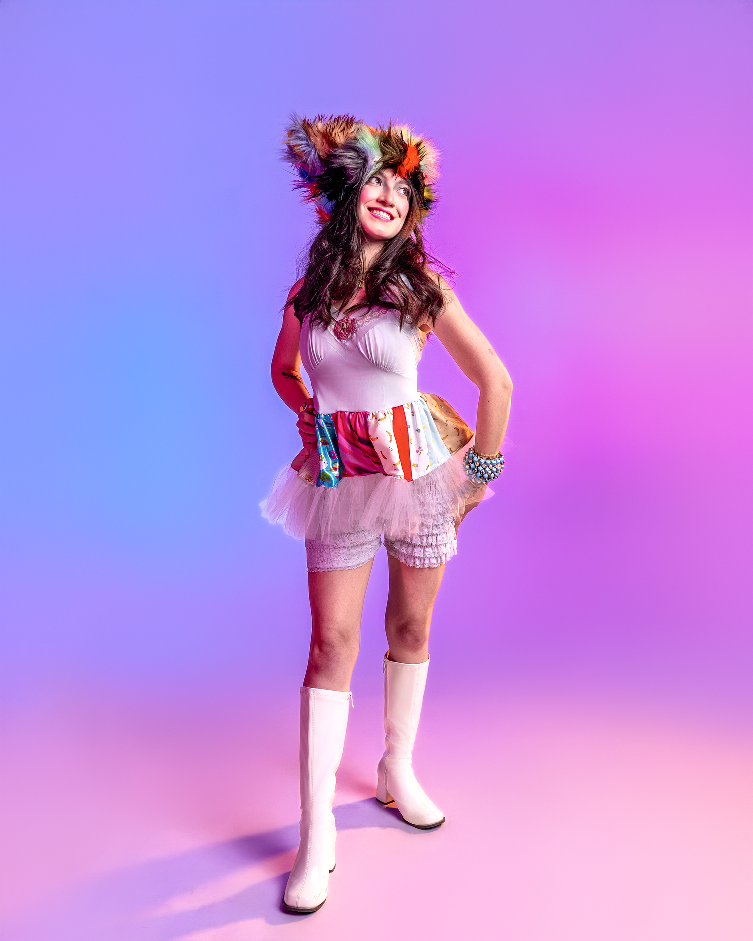 White retro-inspired outfit with boots captured in dynamic pose against gradient backdrop.