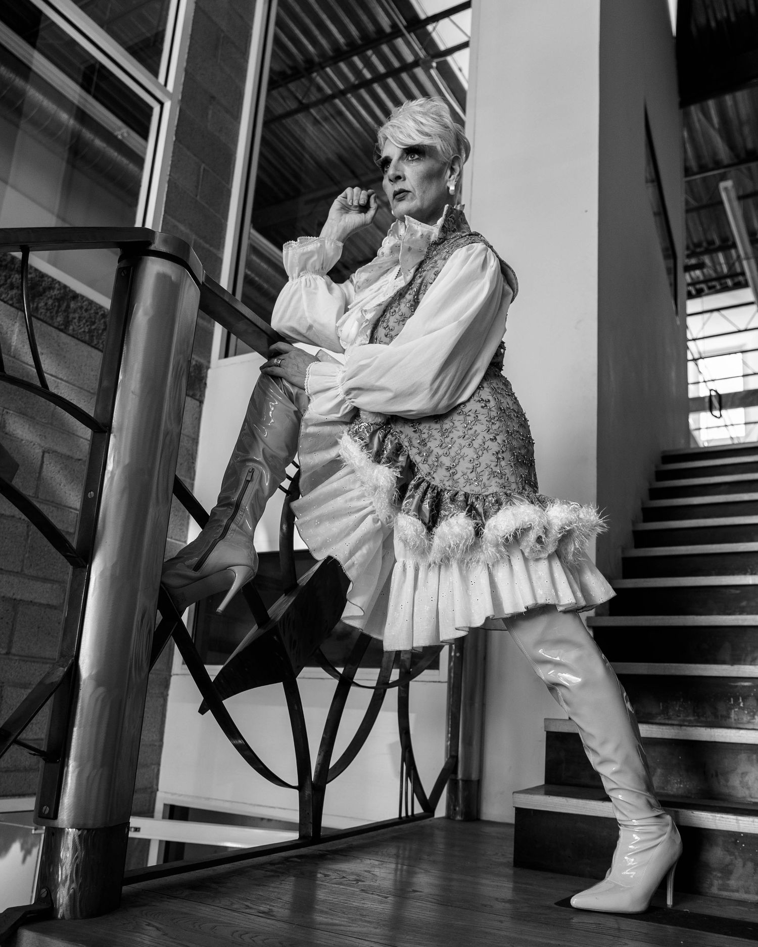 Black and white photo sequence showing boots and ruffled dress on stairs creating dynamic movement.