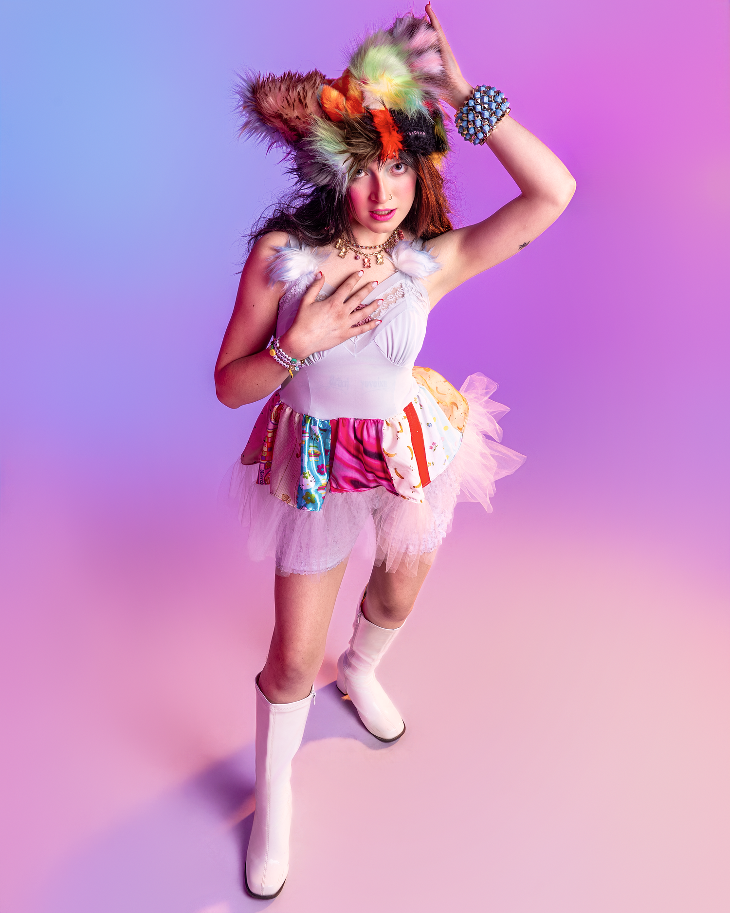 Energetic movement captured in white tulle outfit with colorful accessories on gradient background.