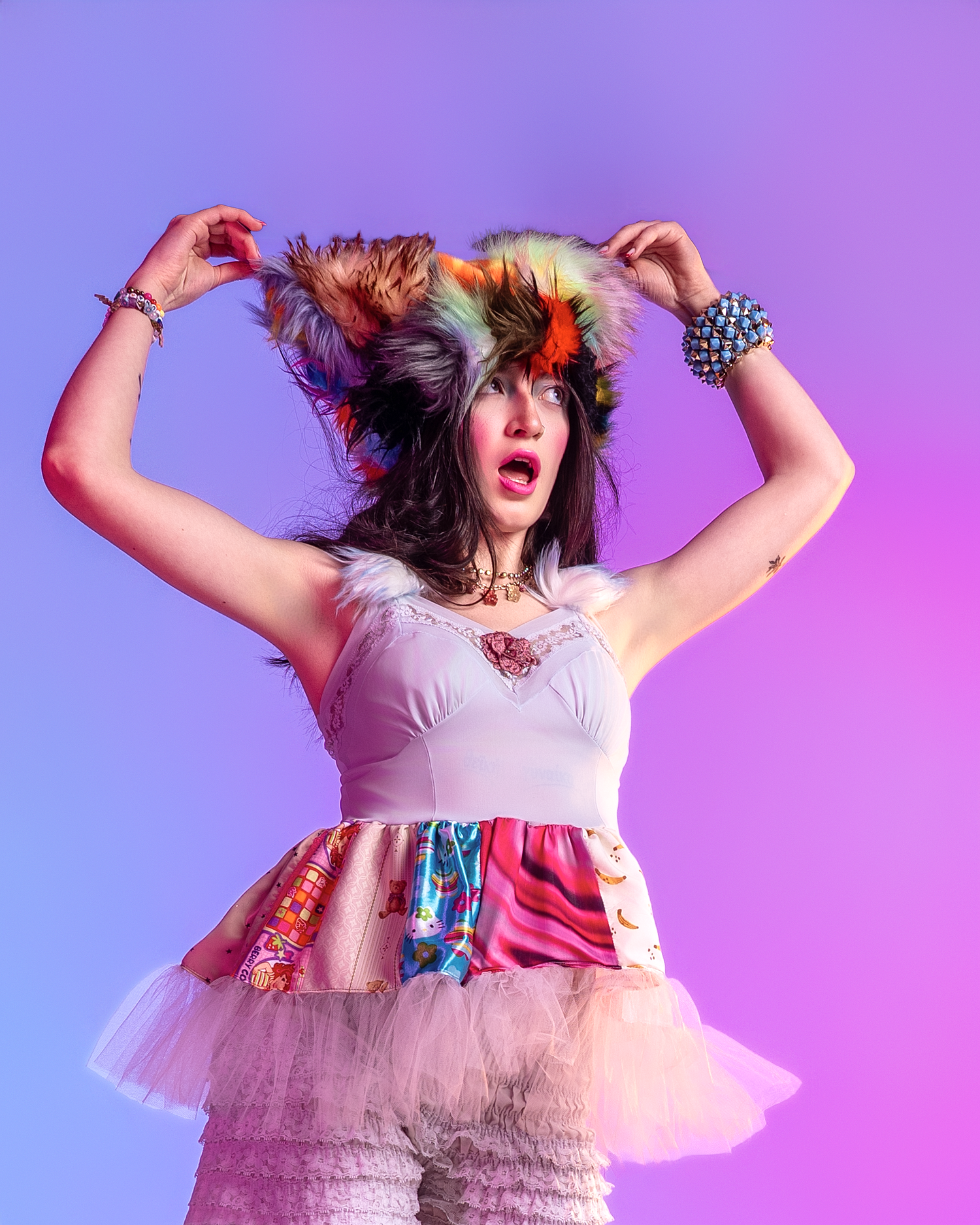 Expressive dance pose in white tulle dress with decorative elements against purple backdrop.
