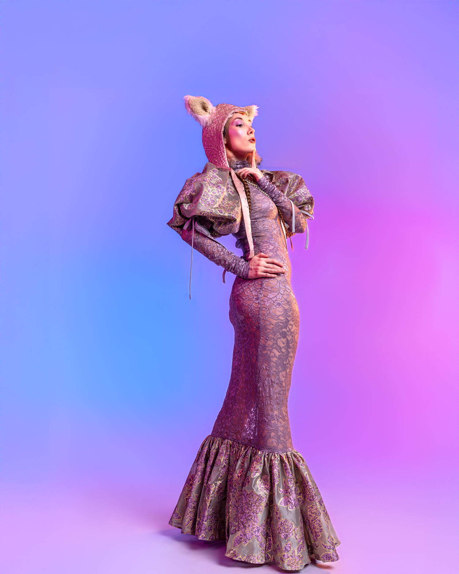 Long purple dress with ruffled hem shown in dynamic fashion pose.