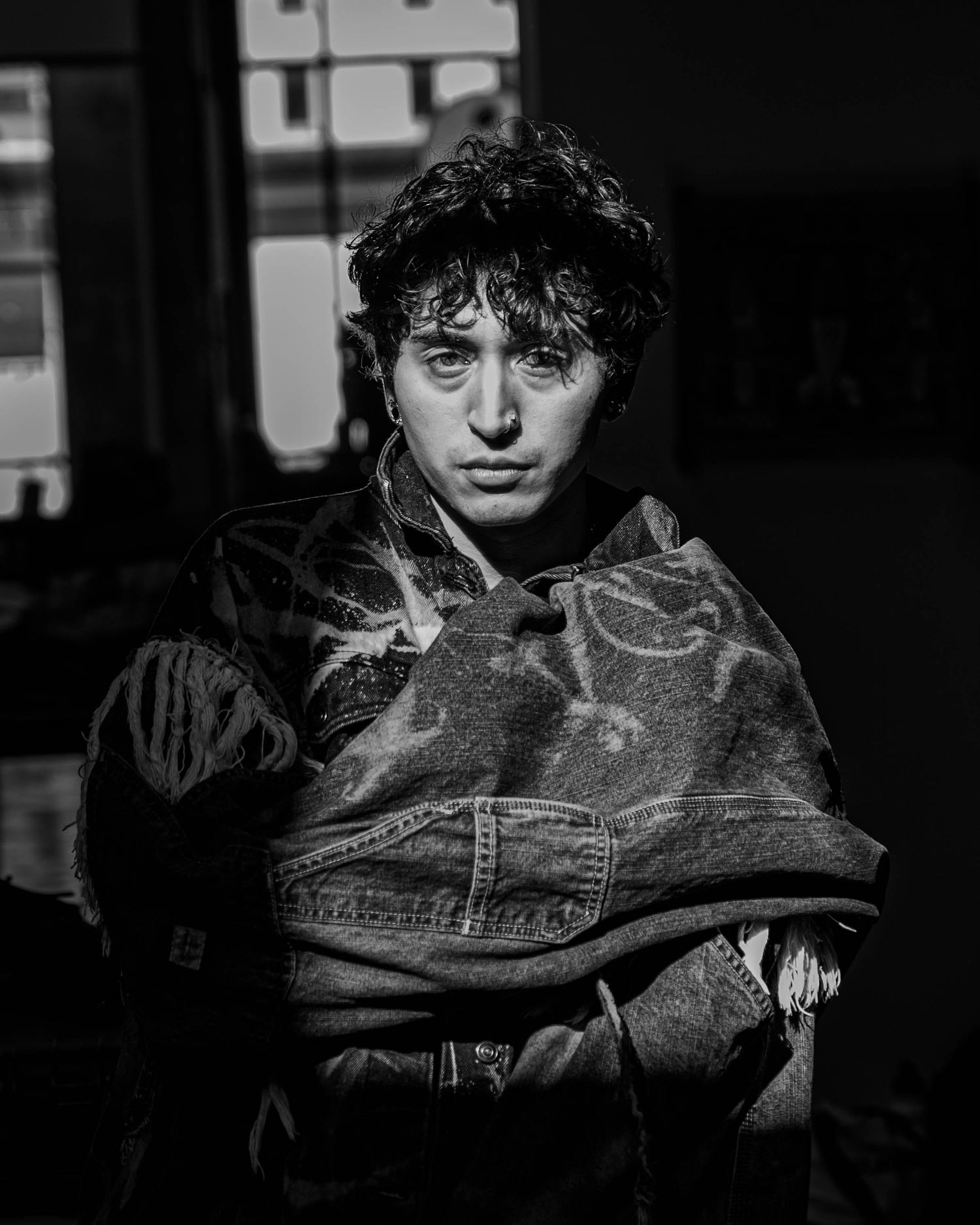 Artistic black and white portrait series featuring denim jacket styling.