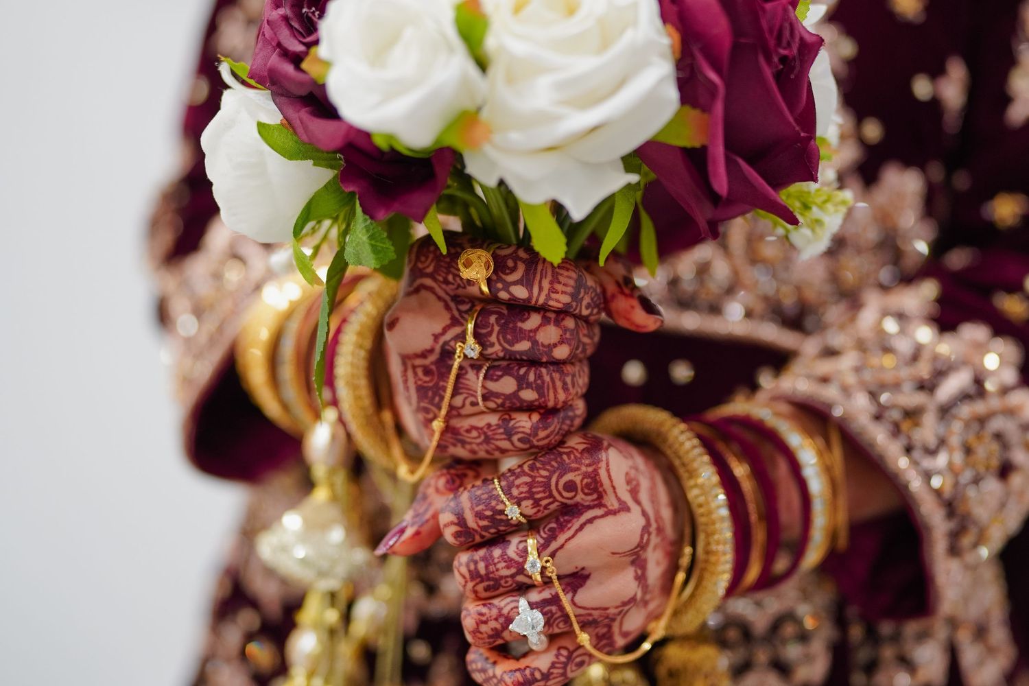 Vibrant wedding bouquet featuring white roses and deep colored flowers.