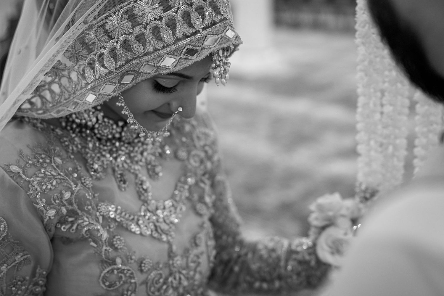 Intricate beadwork and embellishments on luxurious wedding attire sparkle in black and white.