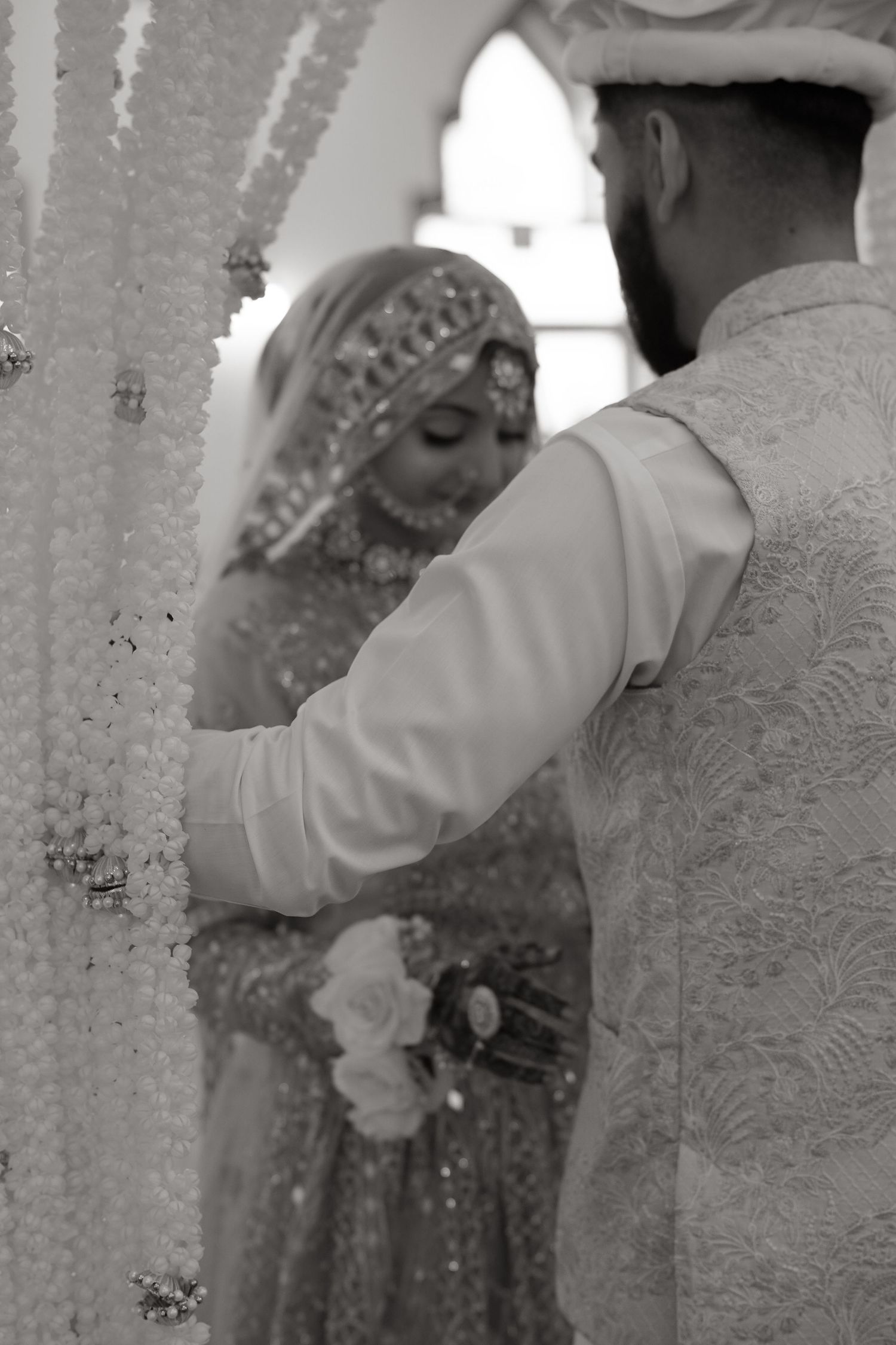 black and white edit of couple photoshoot showing a couple embracing during a romantic wedding moment.