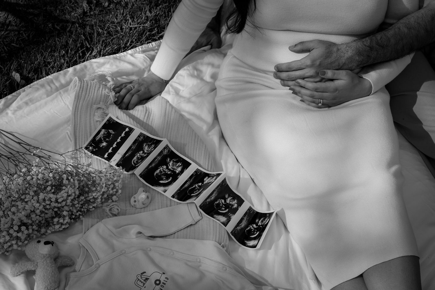 Intimate black and white photograph capturing maternity photoshoot.