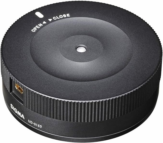 Sigma USB dock lens calibration device in black on white background.