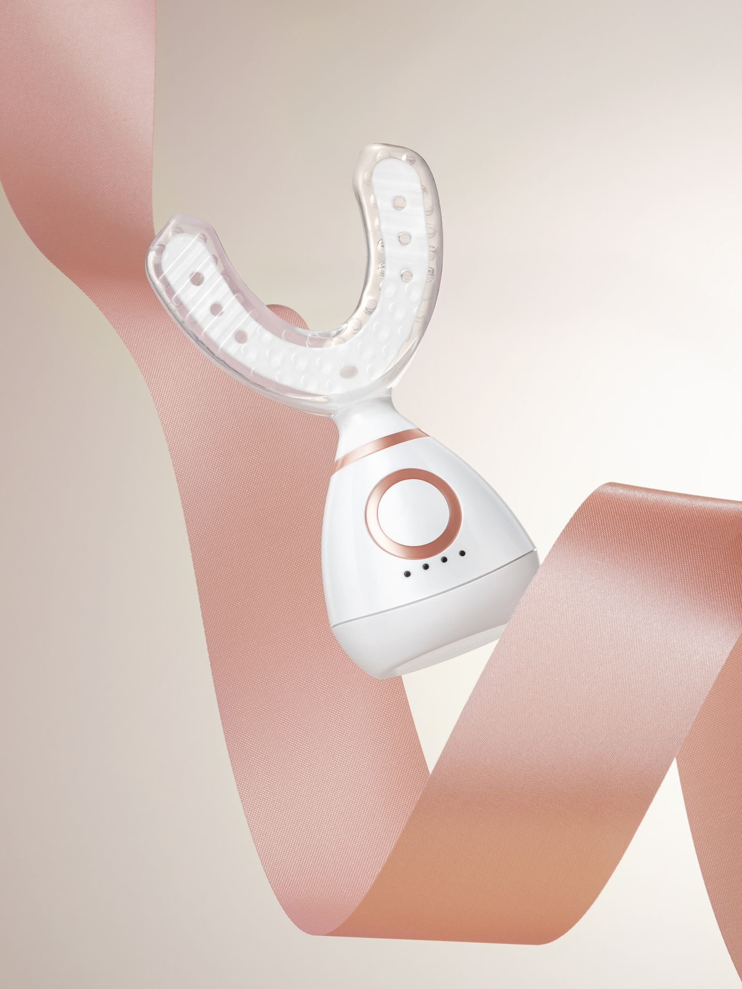 Uplift skincare white device floating against a lush luster cream pink ribbon on a light cream background with a gradient to the right.