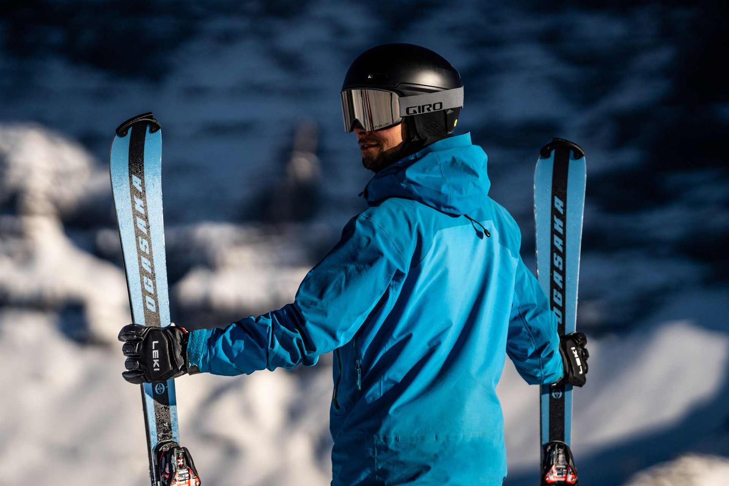Sportlifestylefotografie: Skifahrer halt seine Ski, geniesst die Aussicht – im Hintergrund die Eigernordwand