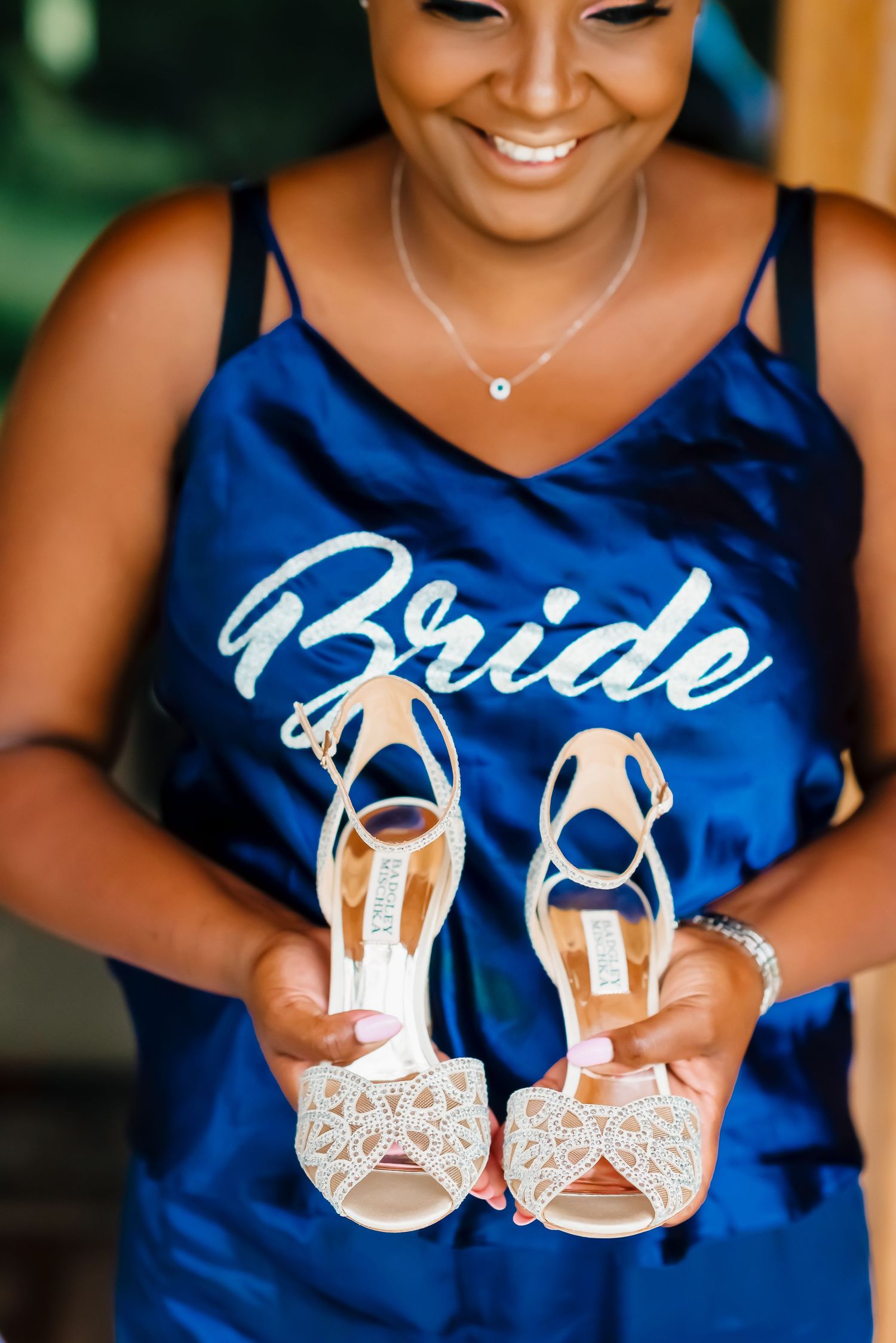 A sequence of close-up shots showing elegant white bridal sandals held against a royal blue bridesmaid dress background.