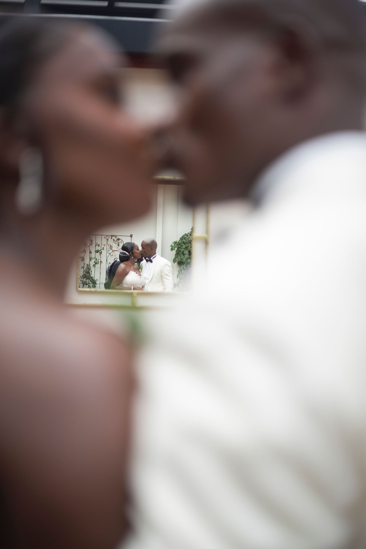 A close-up wedding ceremony shot showing a tender moment between the couple during their vows.