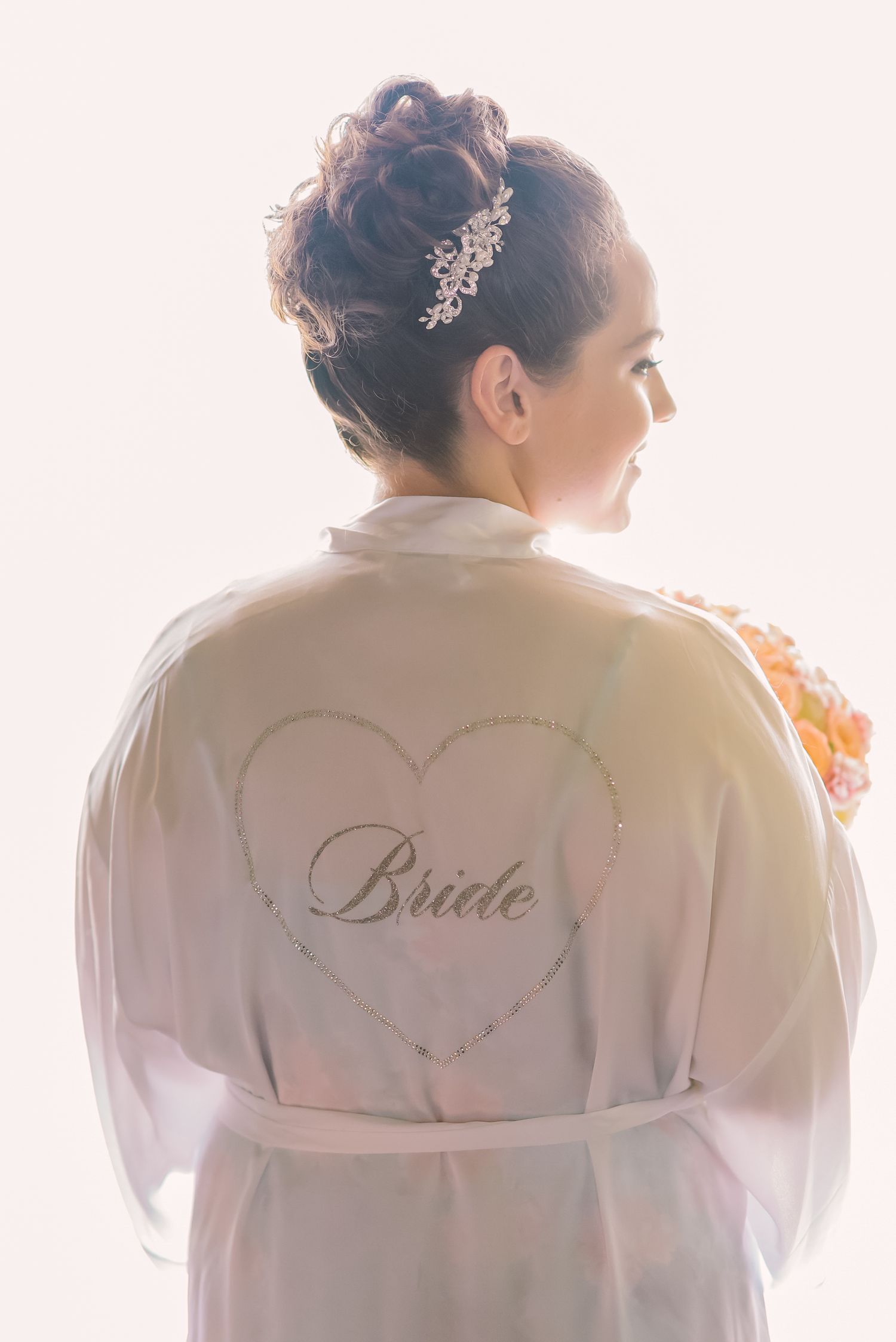A series of soft, dreamy photos showing the back of a white robe with 'Bride' embroidered in elegant script.