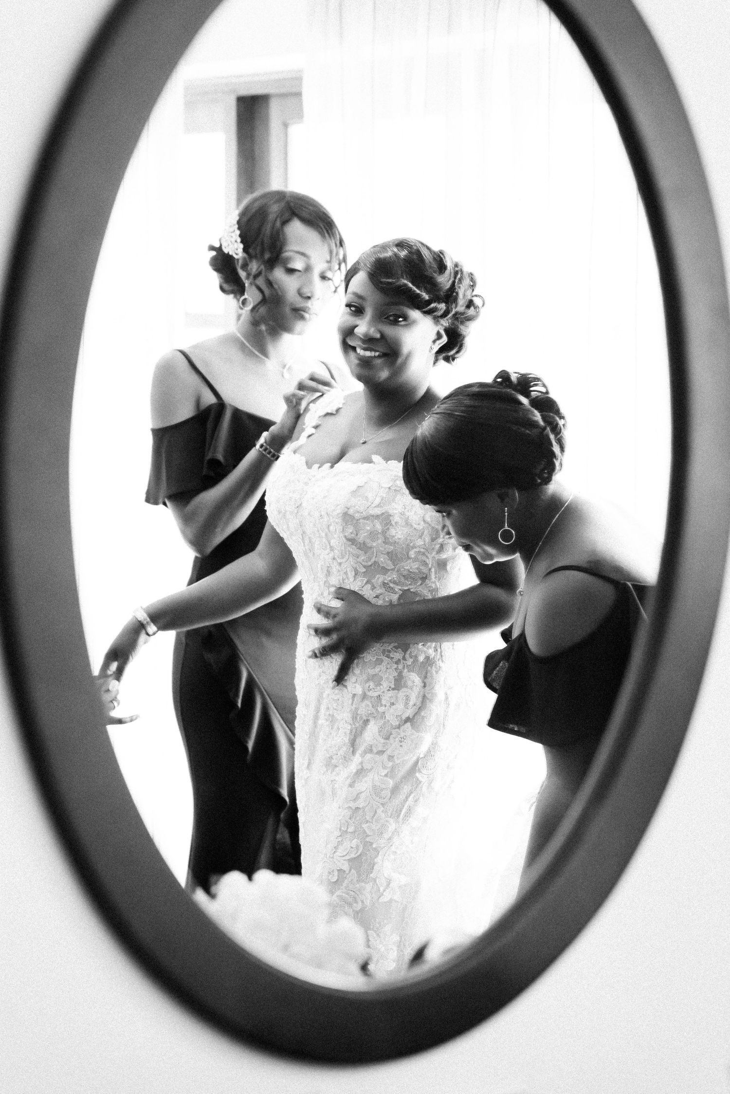 A series of oval-framed black and white photos showing wedding preparation moments with a bride and attendants.