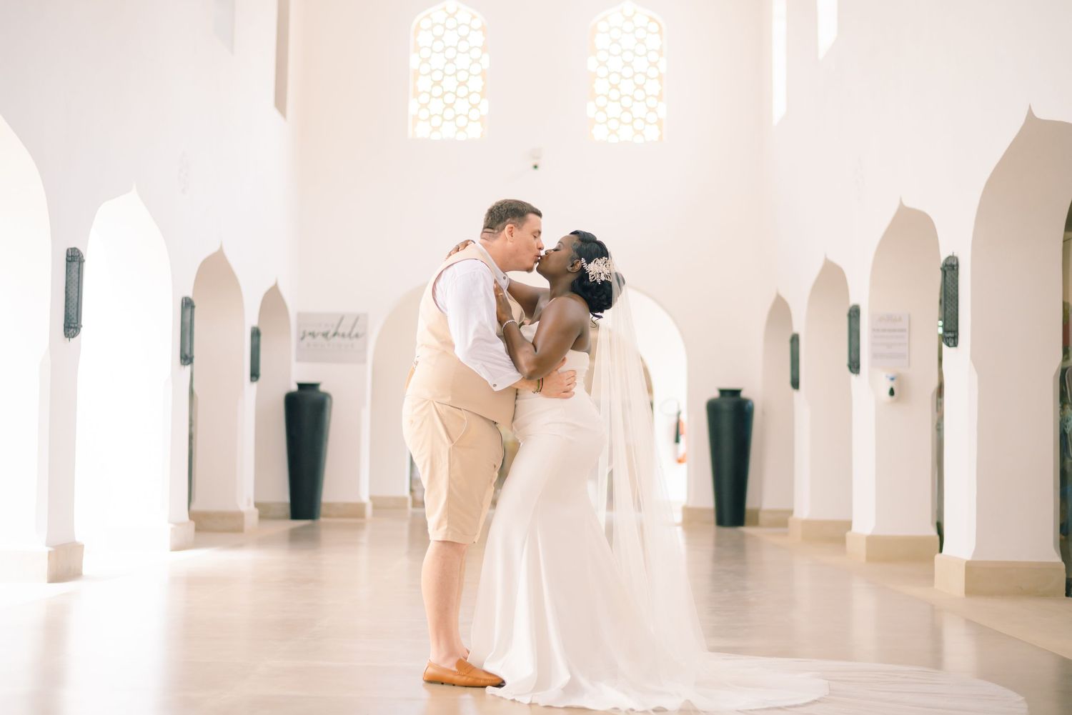 Elegant white arched hallway with minimalist architectural design and natural lighting creates a serene atmosphere.