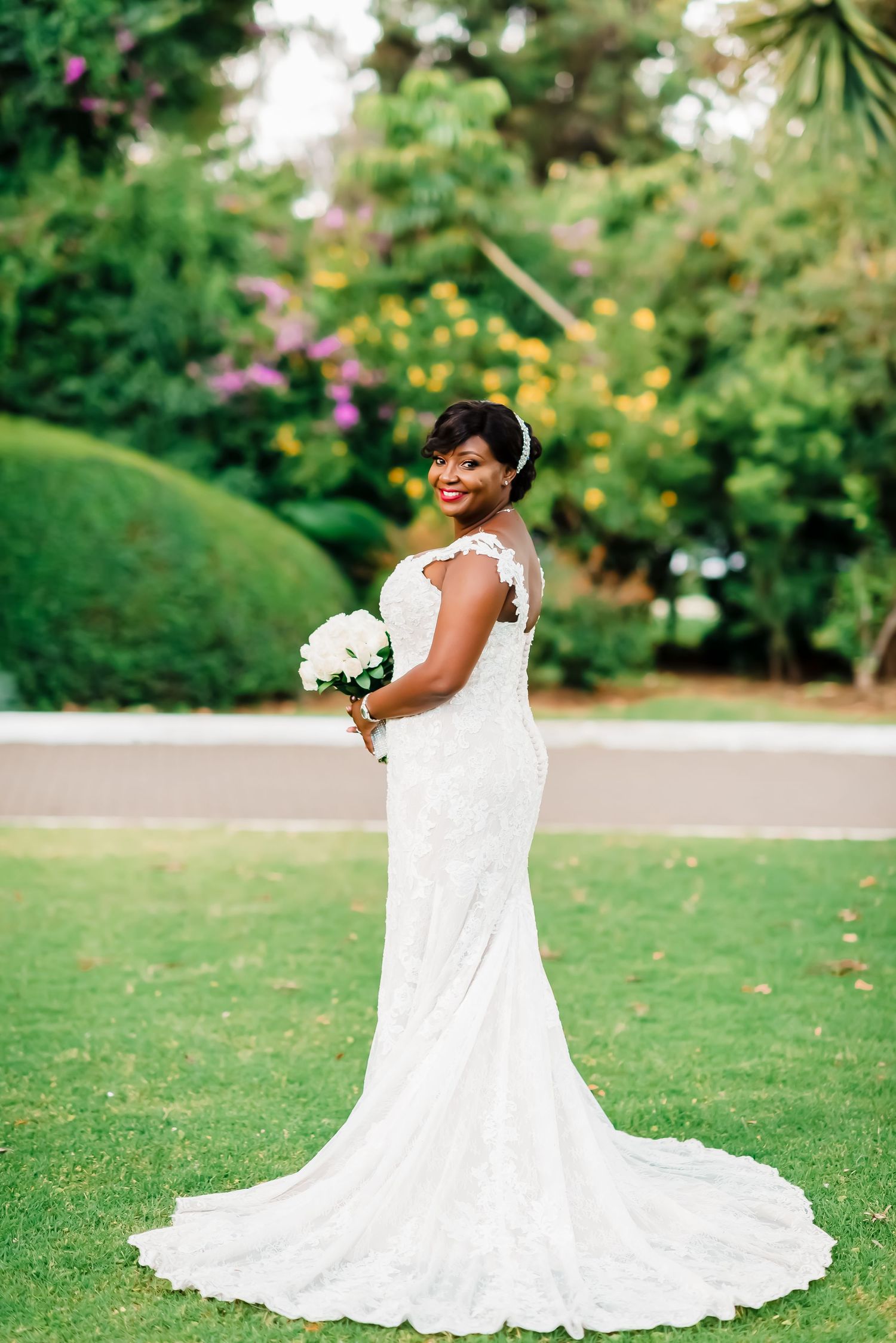 A beautiful wedding portrait series showing a bride in a flowing white gown posing gracefully in a lush garden setting.
