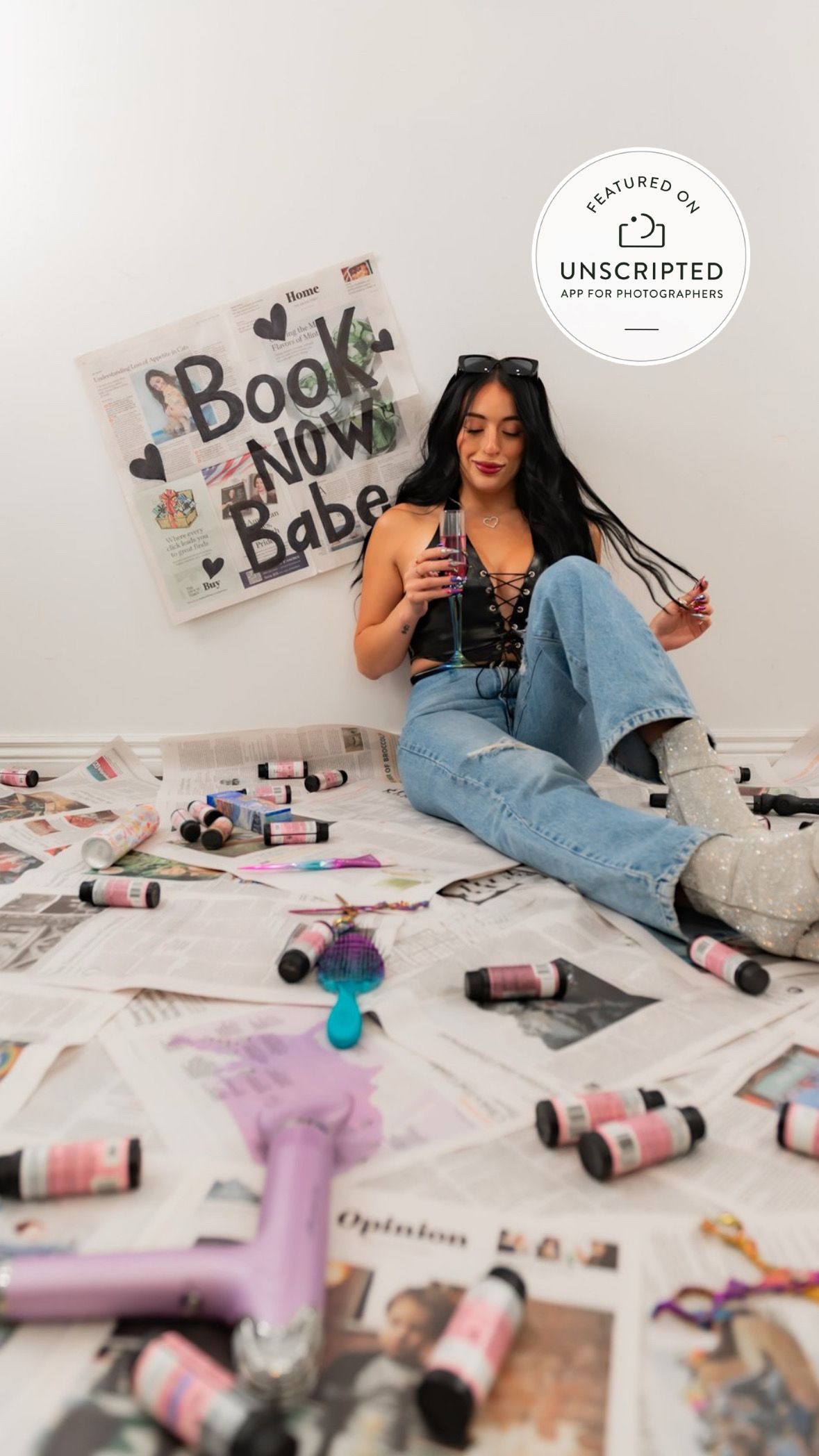 Creative flatlay with photography prints, markers and decorative elements on white surface.