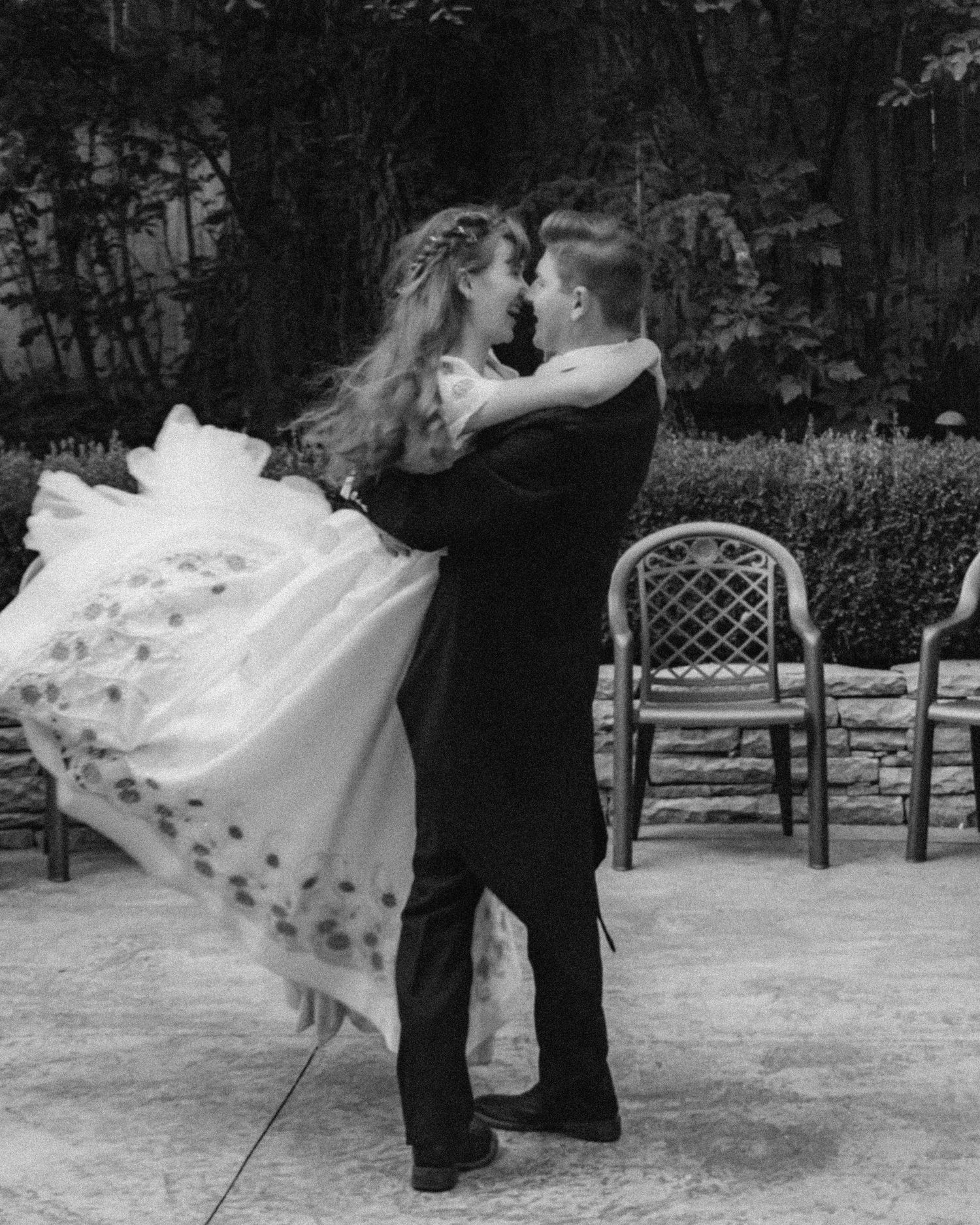 Black and white photo of a couple dancing in formal attire.