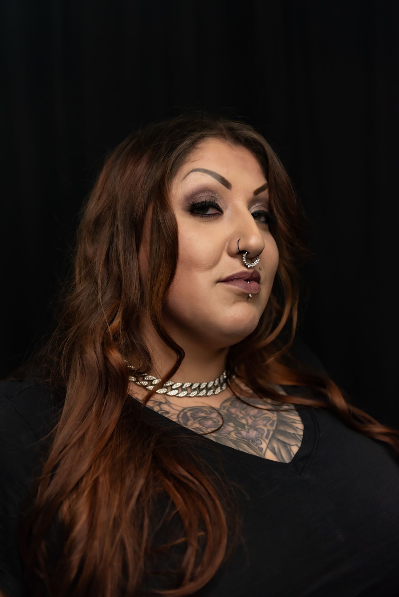 Artistic portrait series showing dark makeup and piercings against black background.