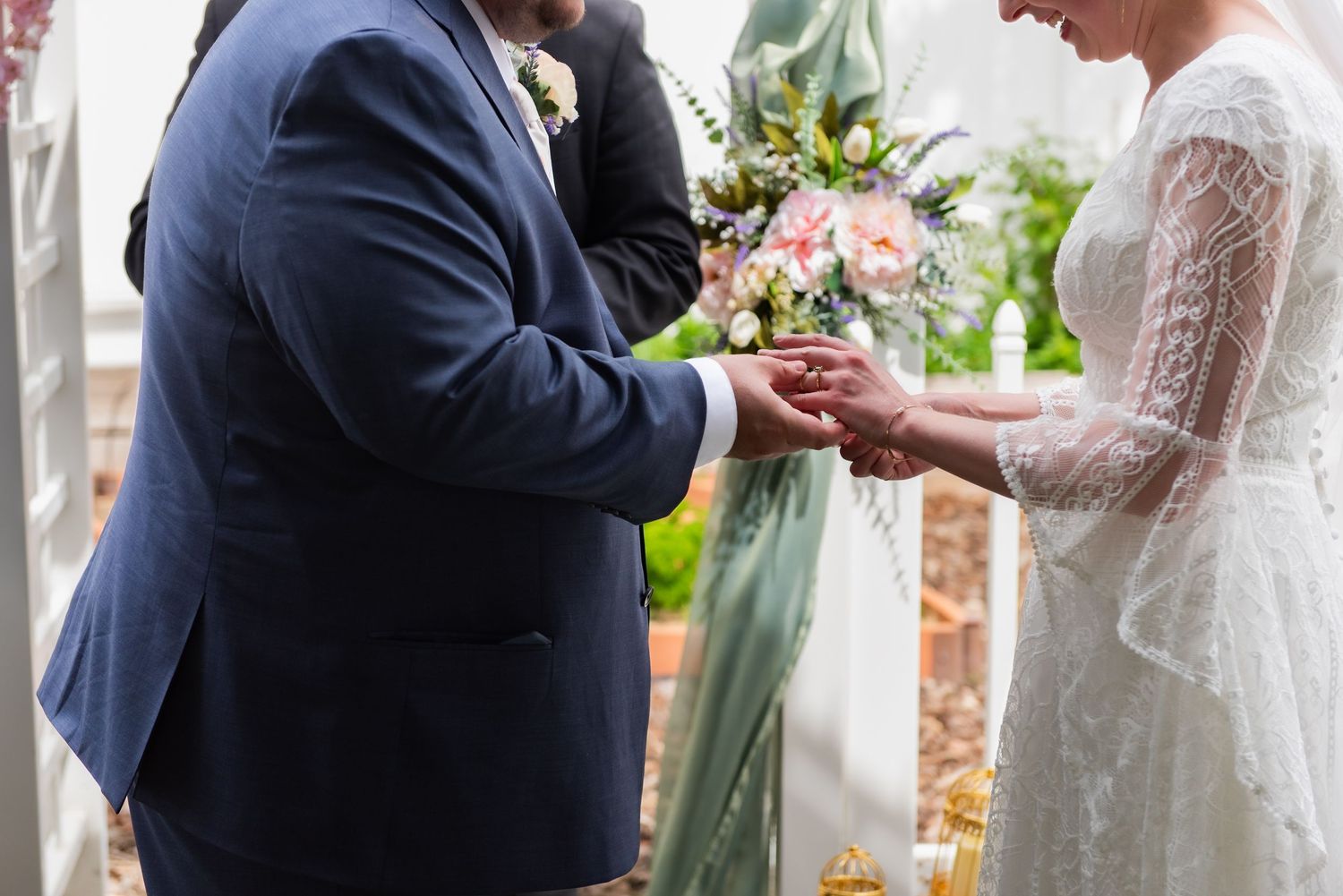 Close-up of wedding ring exchange during ceremony.