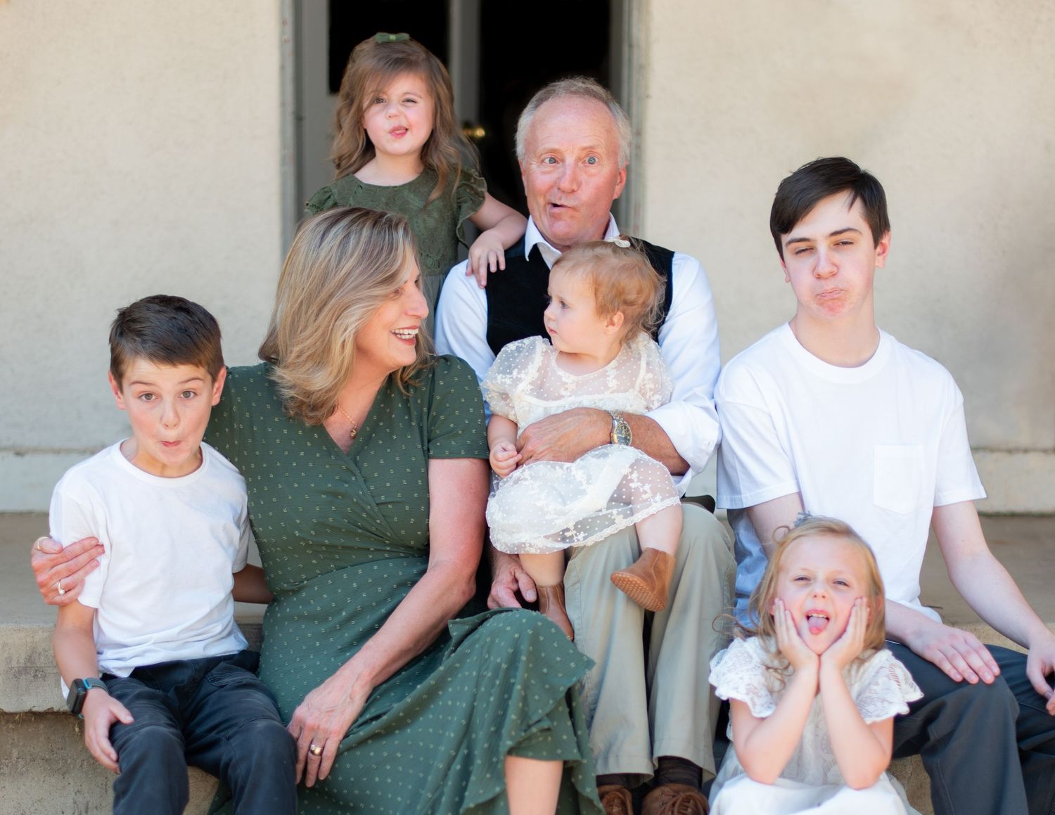 Multi-generational family portrait taken outdoors in casual attire.