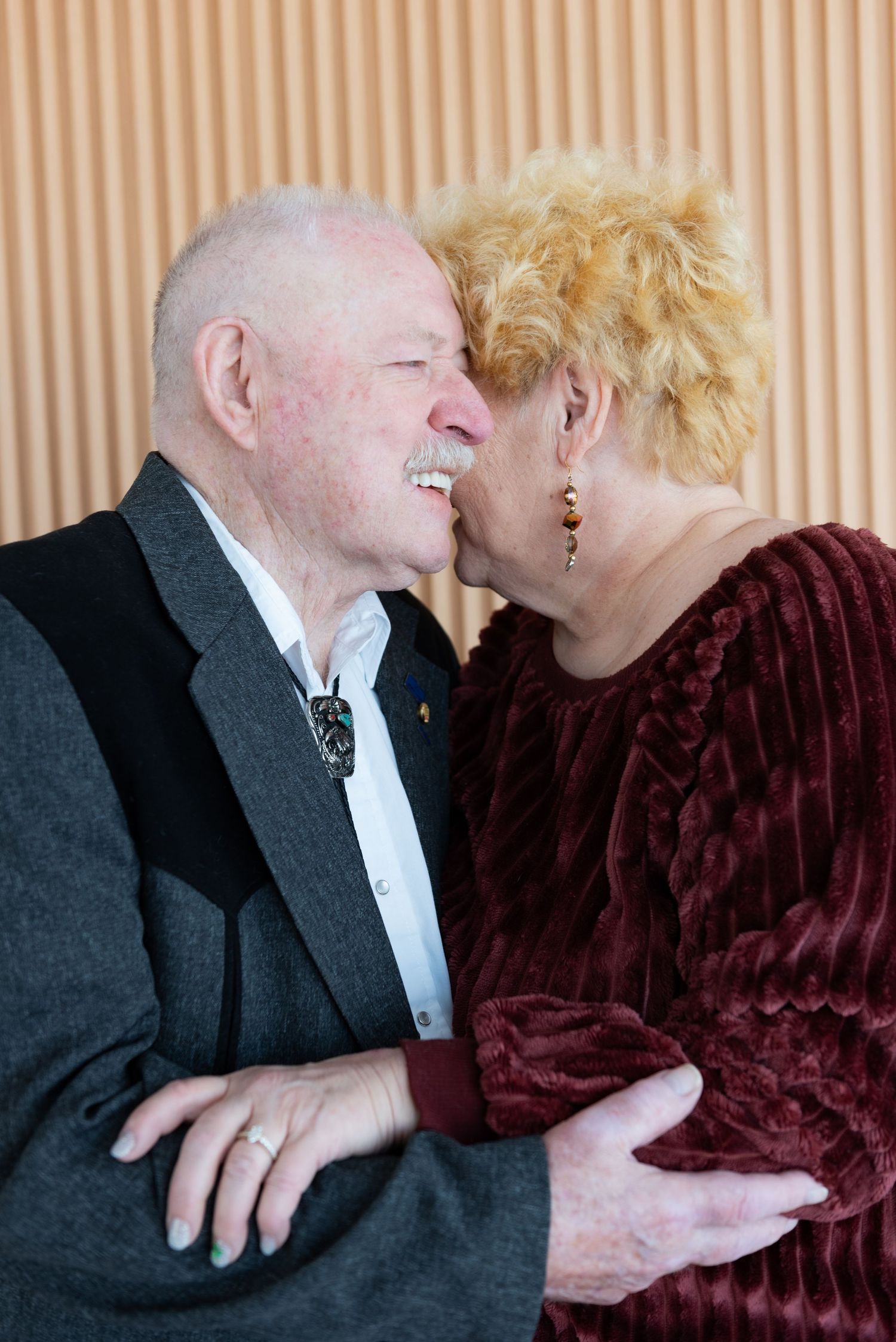 A romantic portrait session with burgundy velvet and formal attire.