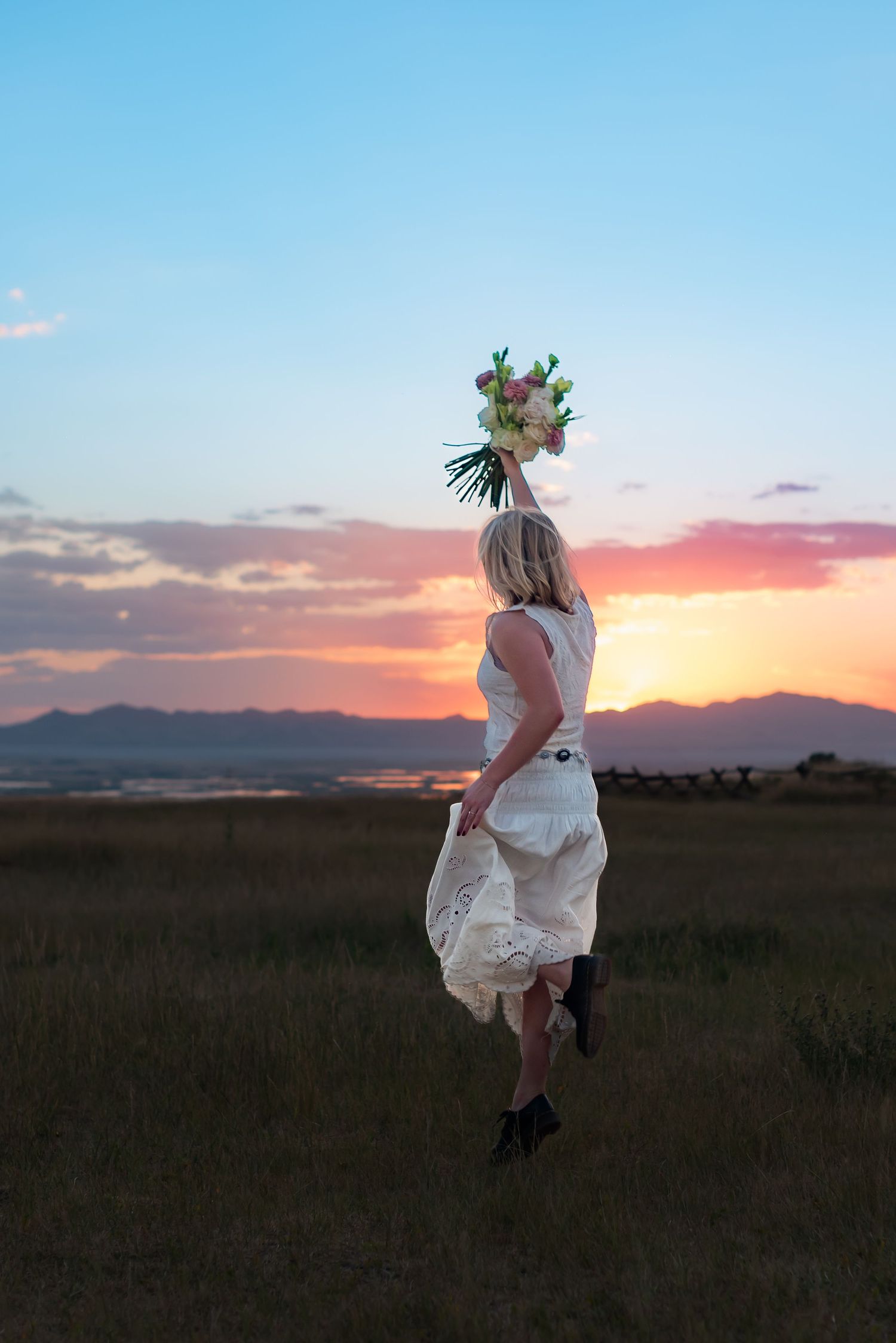 Series of dynamic jumps in a white dress against a dramatic sunset landscape.