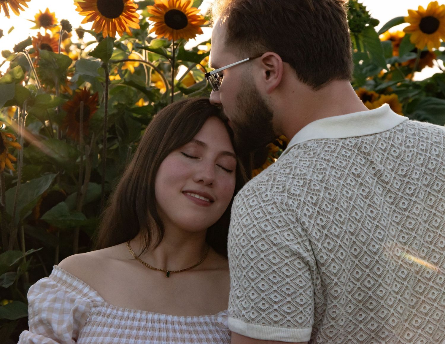 A romantic sunset photoshoot in a sunflower field.