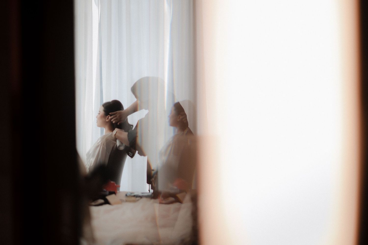 A series of four artistic black and white photos showing silhouettes of figures through translucent curtains.