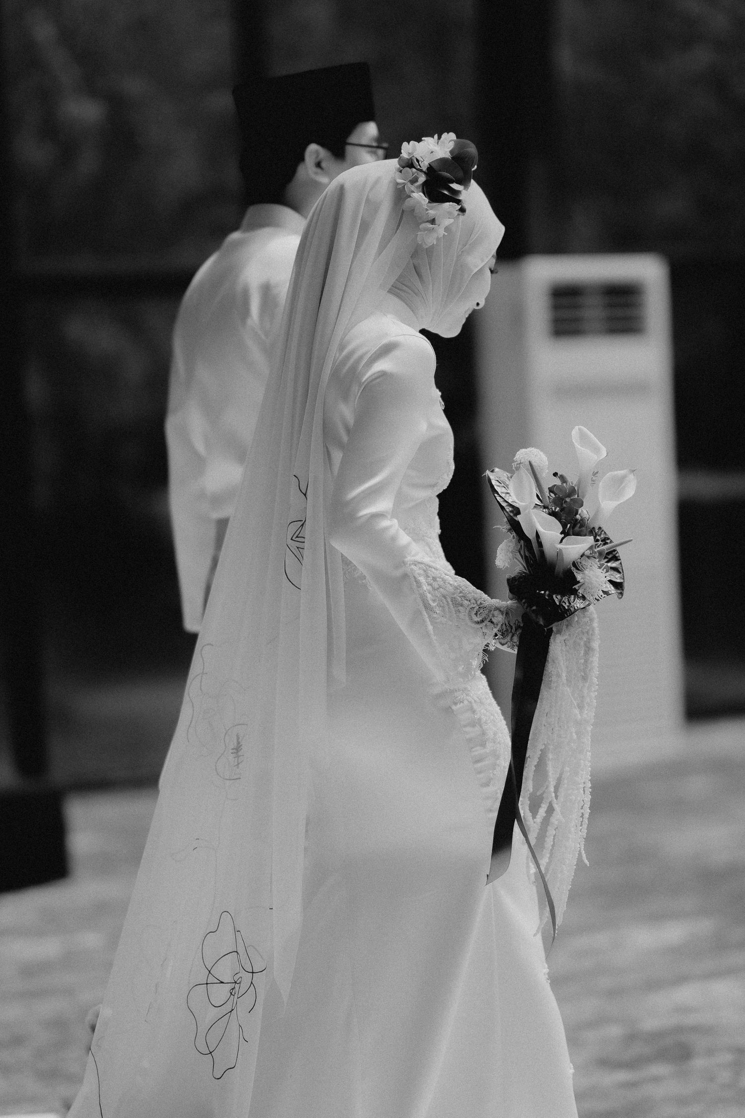 Black and white portrait of bride in elegant long-sleeved wedding dress captured by Crossfadefilm