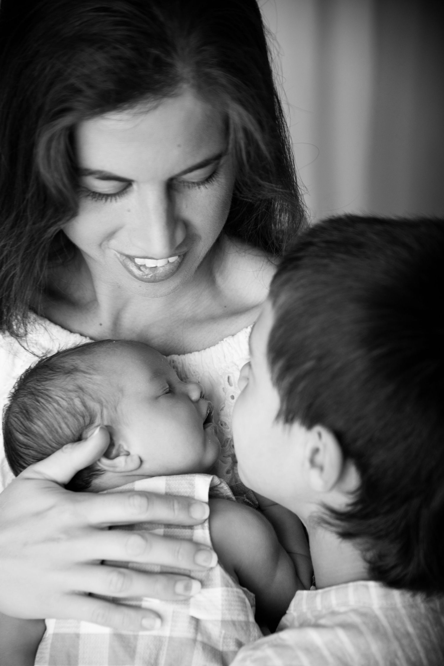 black and white image of a mother and her 2 sons as part of the family photos in their Gold Coast newborn photography session