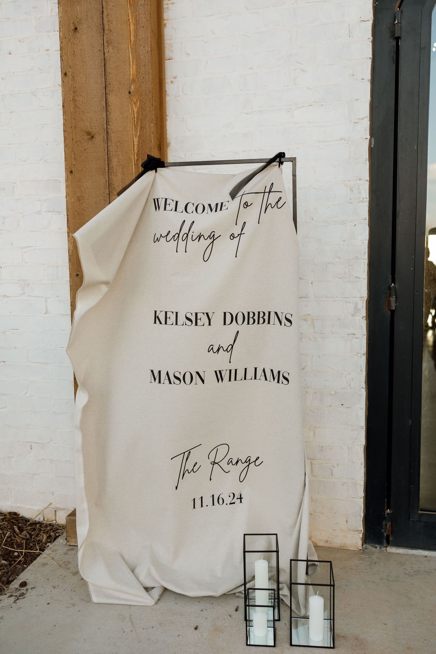 Welcome sign for a wedding at The Range on 11.16.24 with decorative glass candle holders.