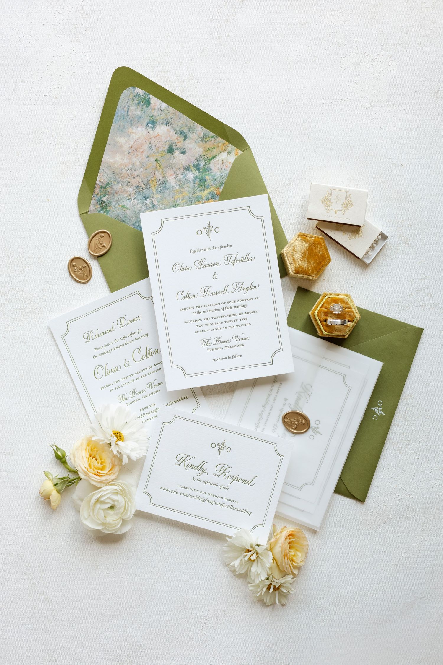 Elegant wedding invitation suite with green envelopes, wax seals, and fresh yellow and white roses.