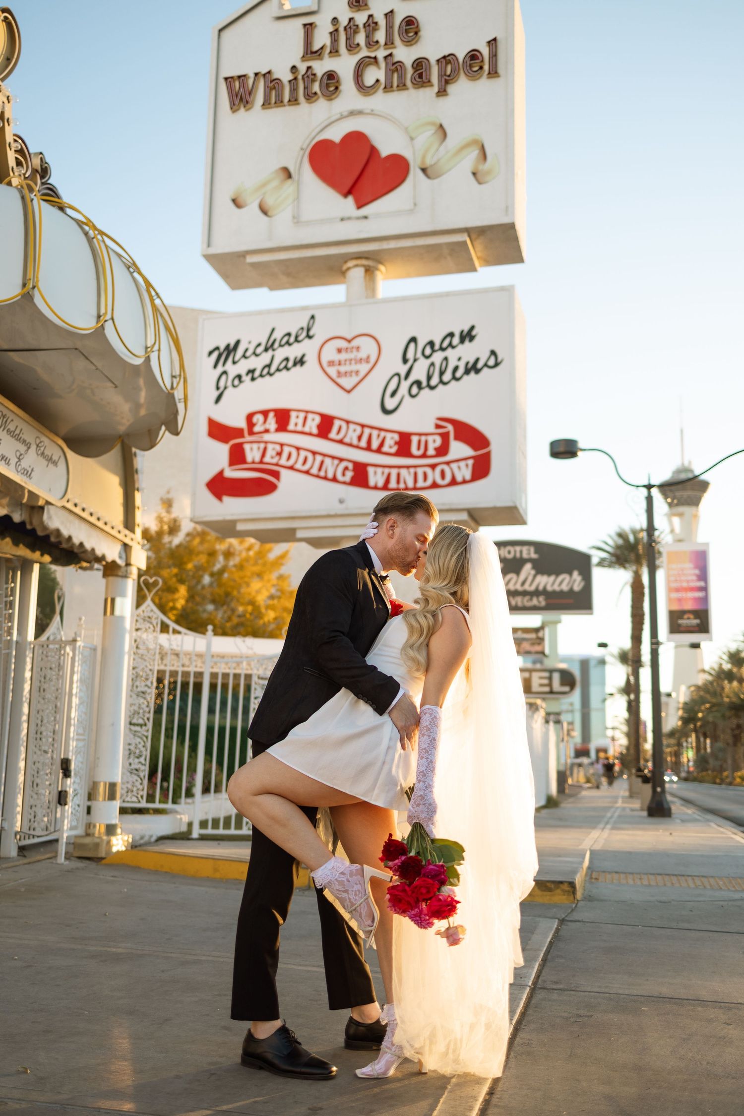 A playful wedding moment captured outside Las Vegas' Little White Chapel.