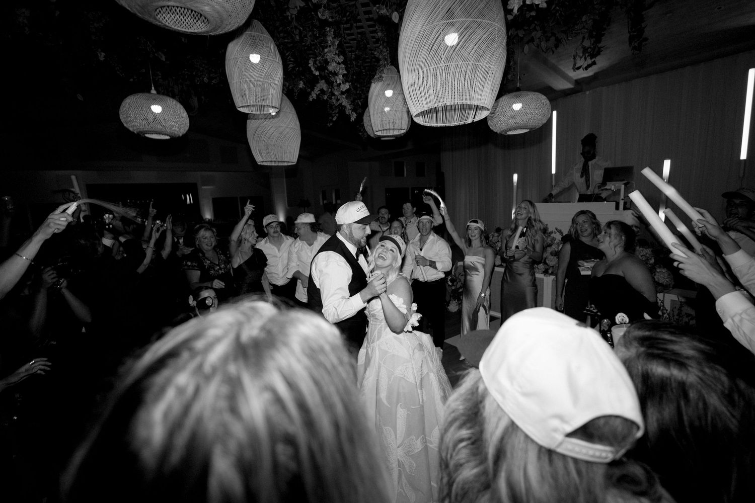Dark and moody reception party scene with paper lanterns and dancing silhouettes.
