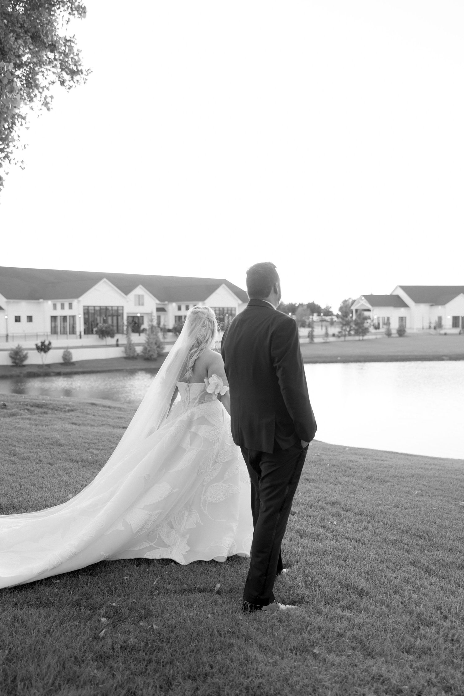 Black and white wedding photography sequence capturing a couple in an expansive outdoor setting.