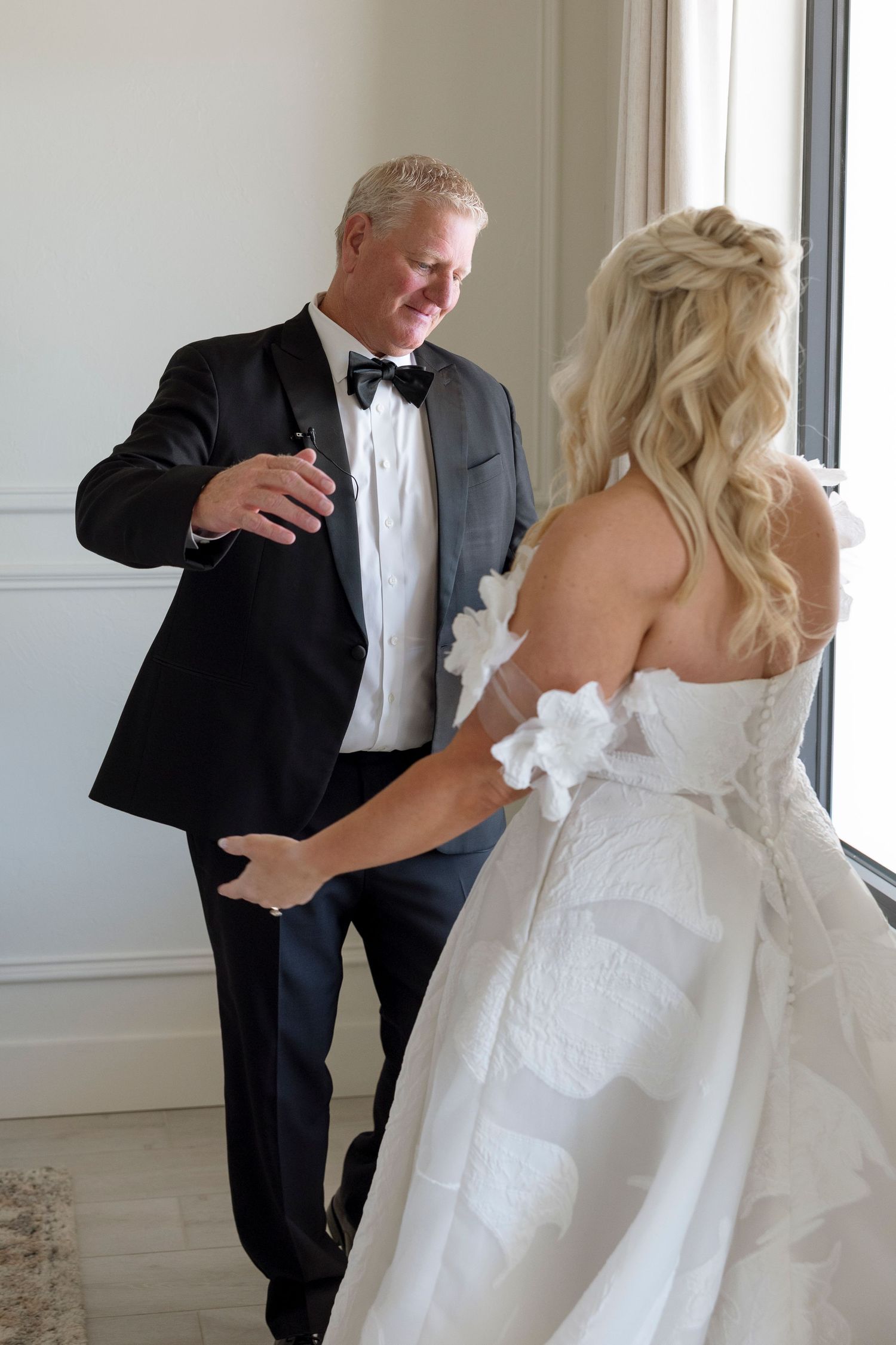 Playful candid moments between a bride in a white gown and someone in a black tuxedo during a wedding celebration.