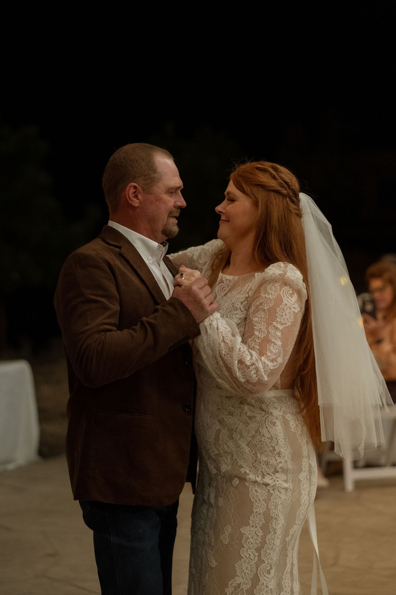 An emotional dance captured during wedding reception under soft evening lighting.