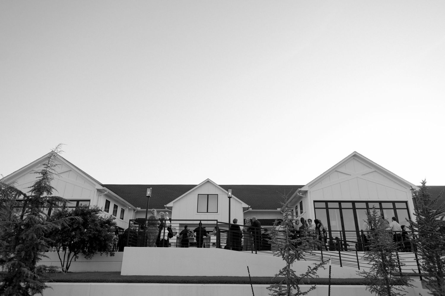 Black and white panoramic exterior view of modern residential buildings in a row.