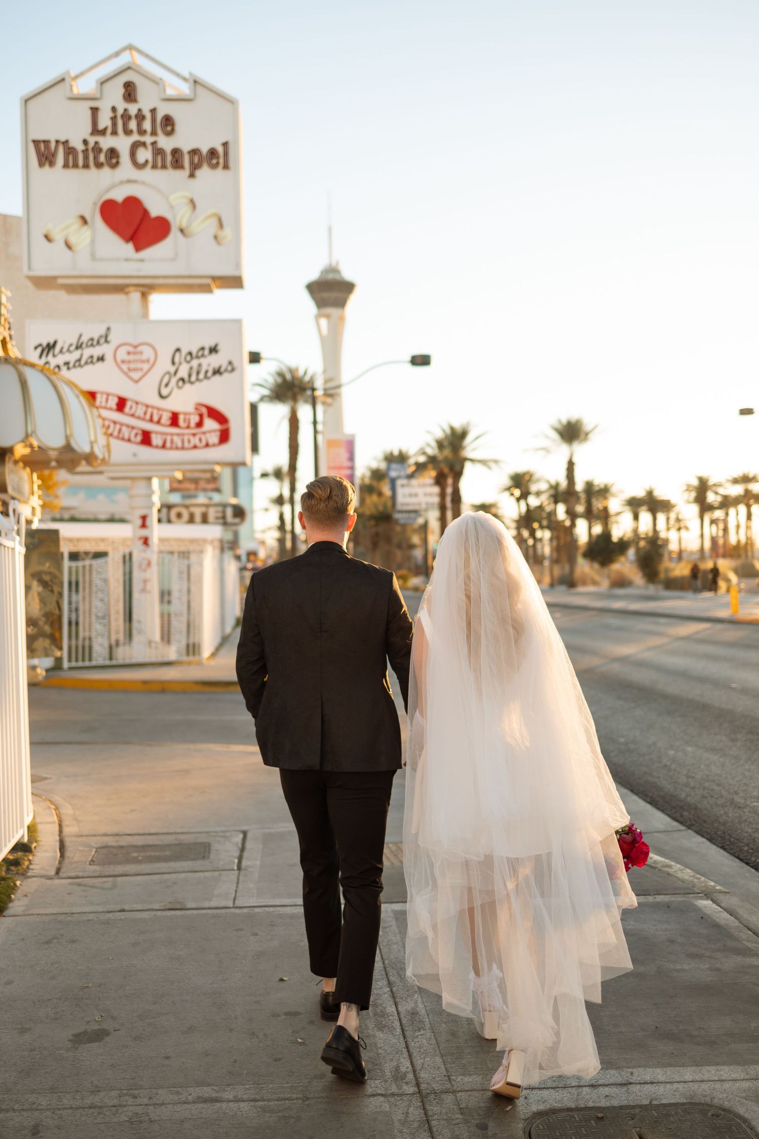 Little White Chapel wedding venue in Las Vegas with palm trees at sunset.