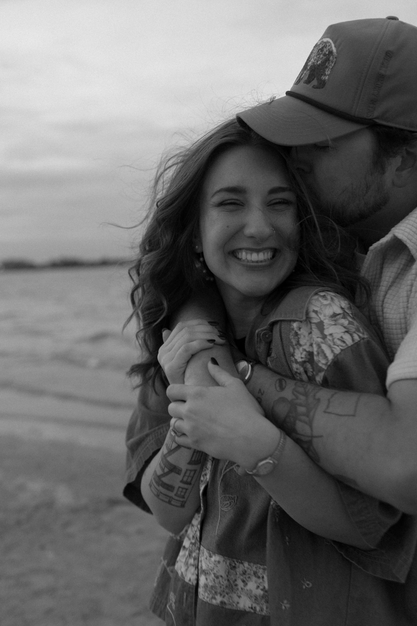 A romantic couple sharing an intimate moment on the beach during golden hour.