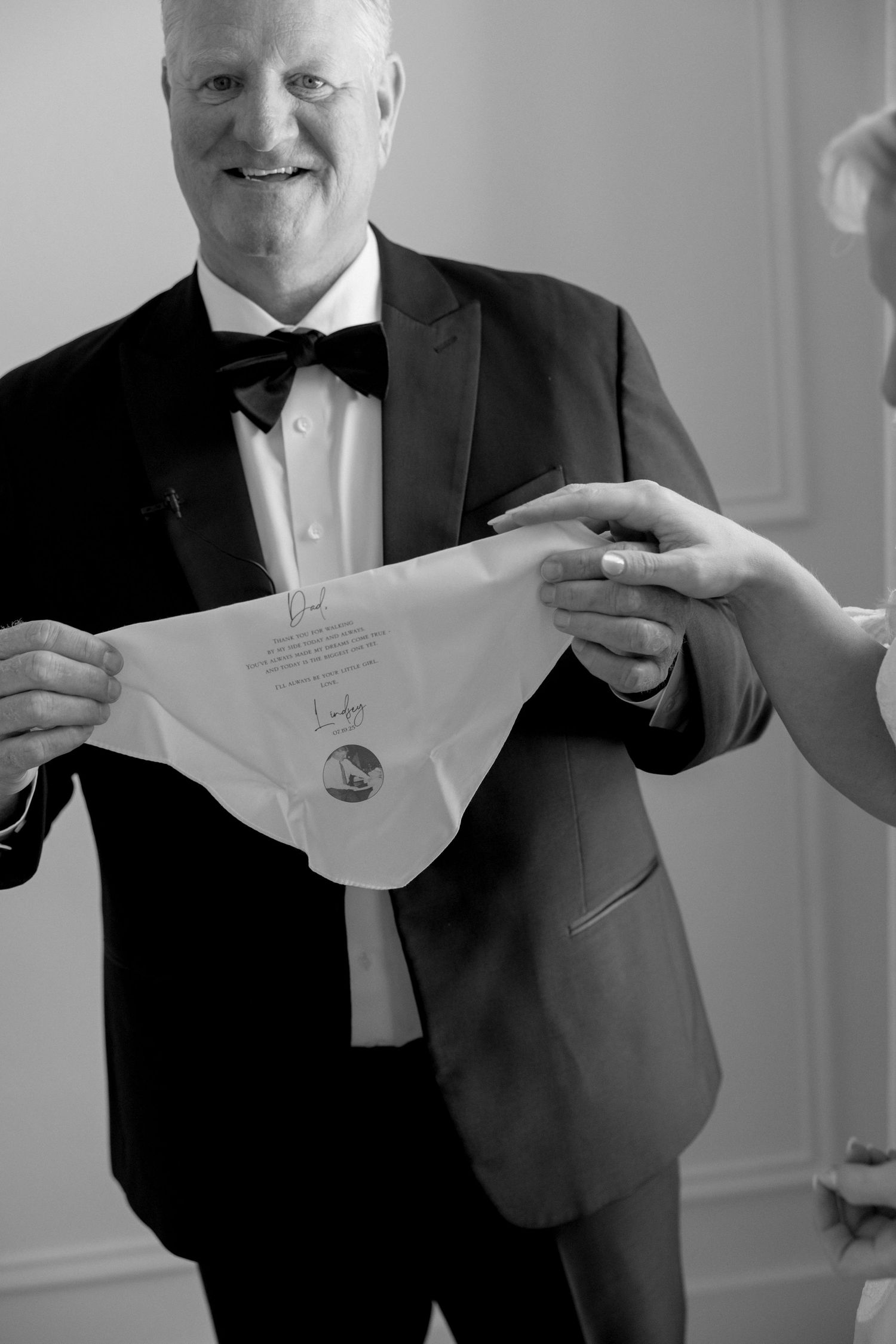 Black and white photo series showing someone holding and displaying embroidered handkerchiefs.