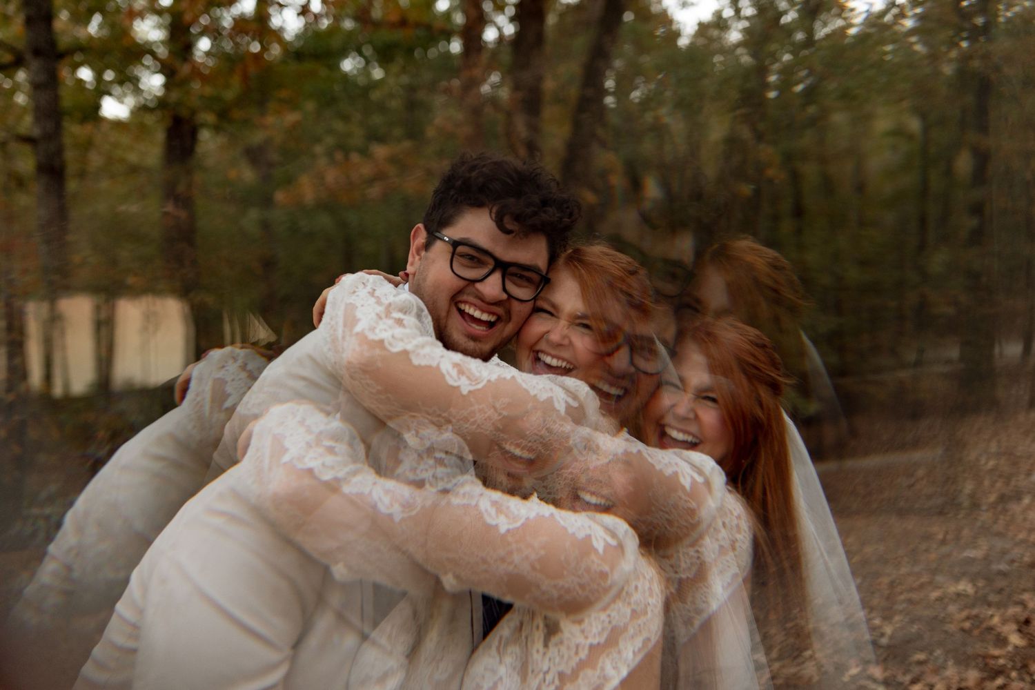 A joyful wedding embrace captured outdoors with laughter and natural emotion.