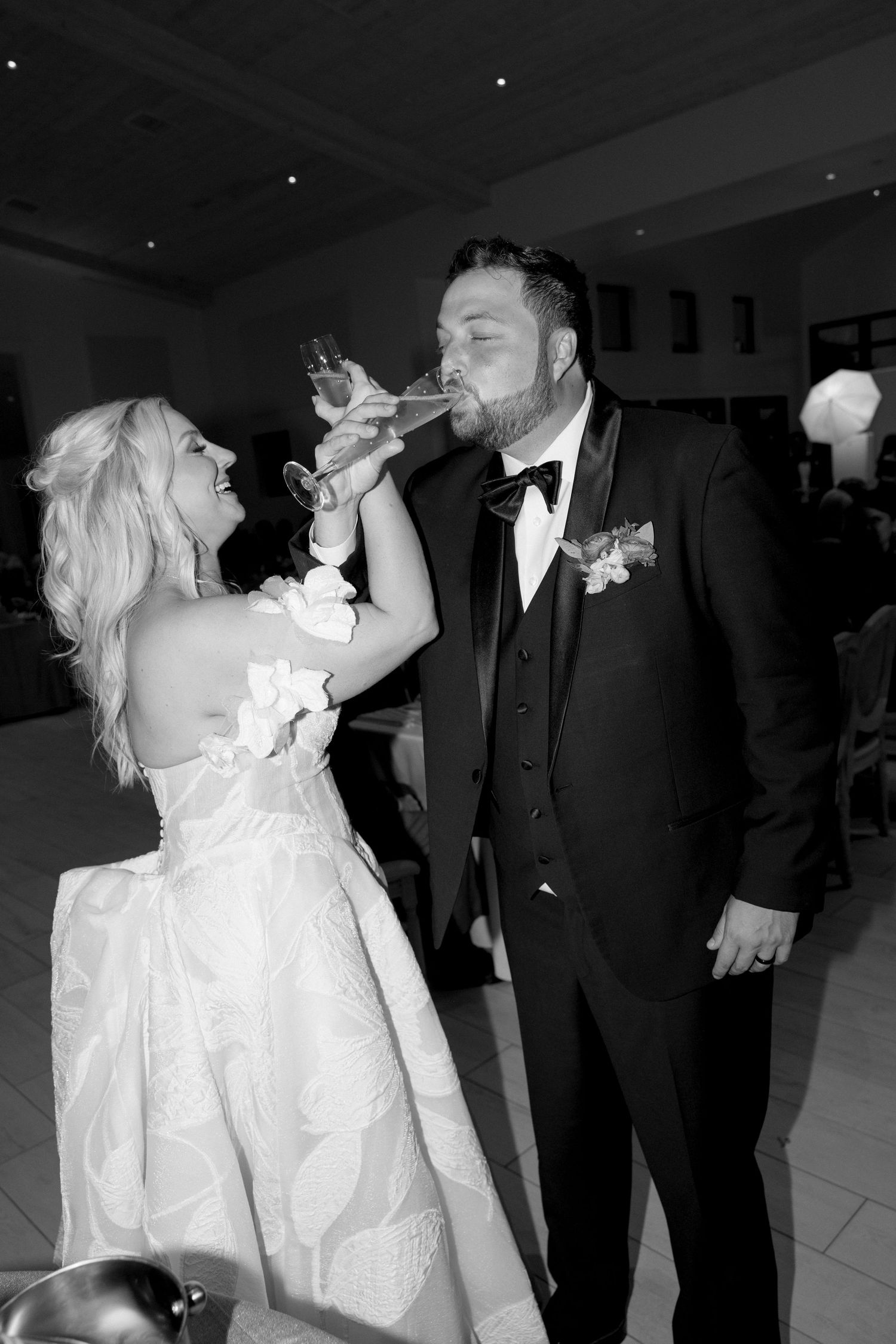 A black and white photo sequence showing a couple sharing a celebratory champagne toast at their wedding reception.