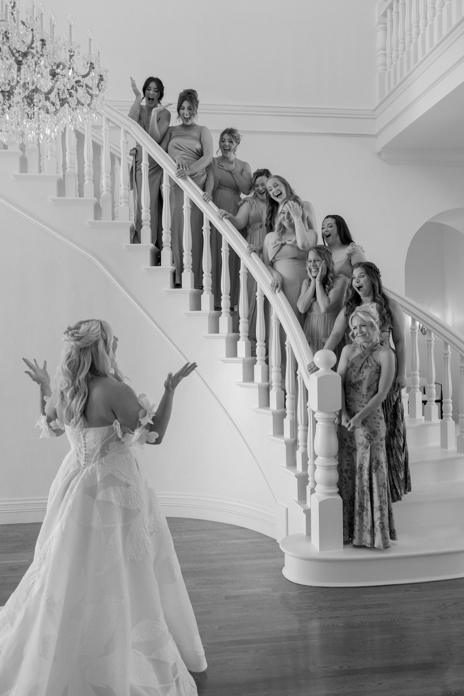 A sequence of joyful moments captured on an elegant white staircase during a wedding celebration.