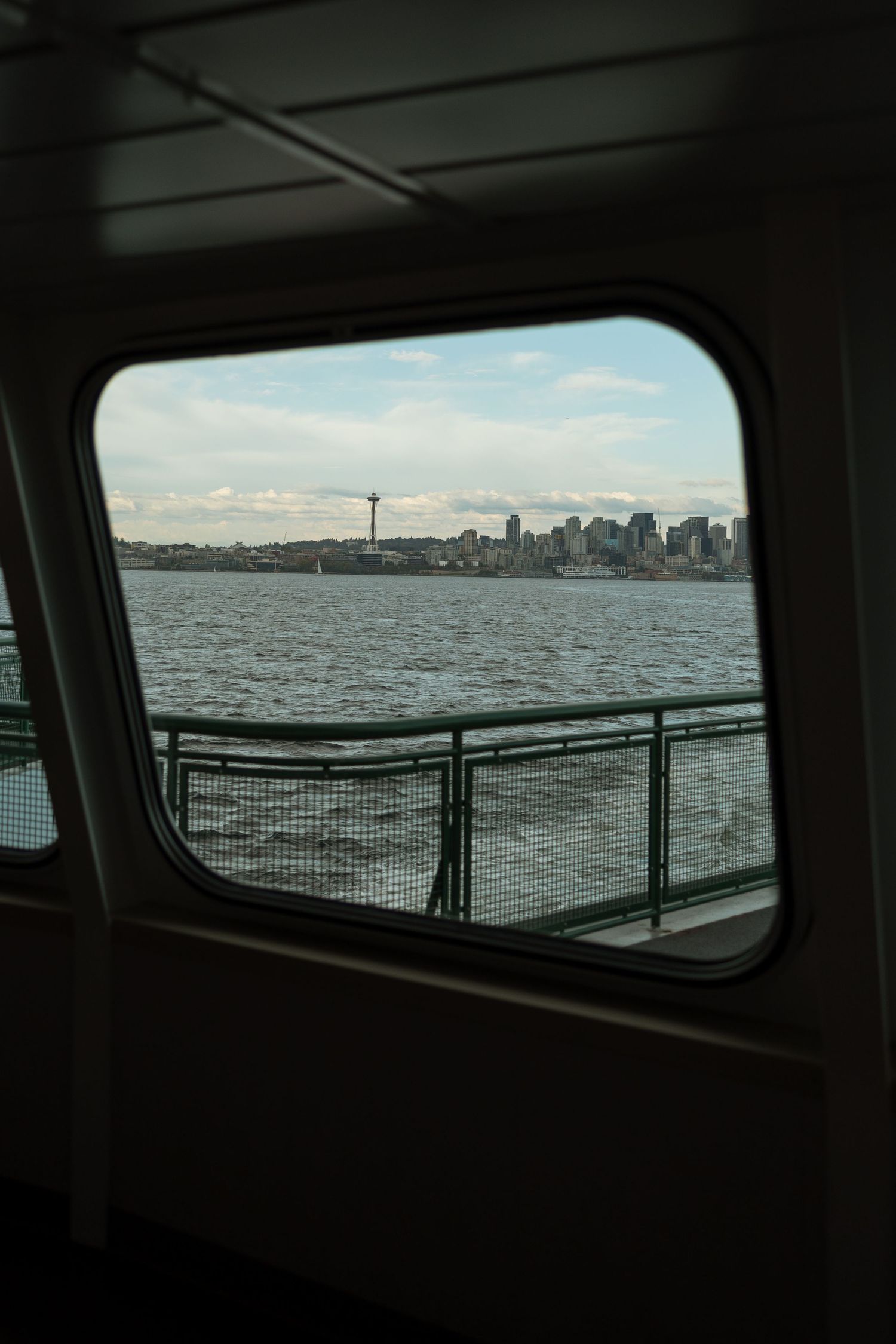View of Seattle skyline and Space Needle through ferry window.