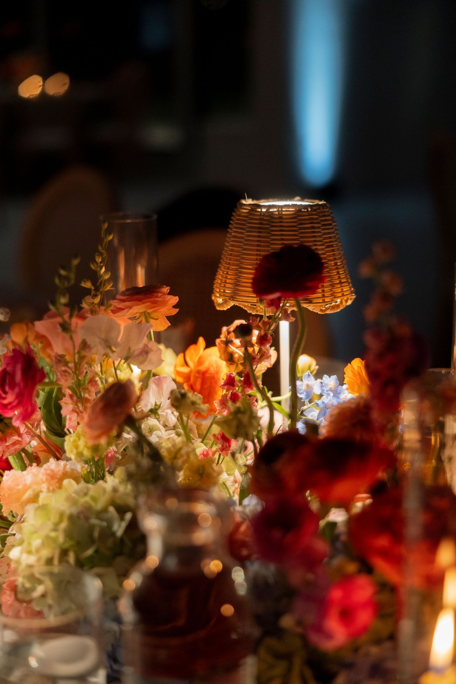 Elegant wedding table decorations with colorful floral arrangements and candlelight creating a romantic ambiance.