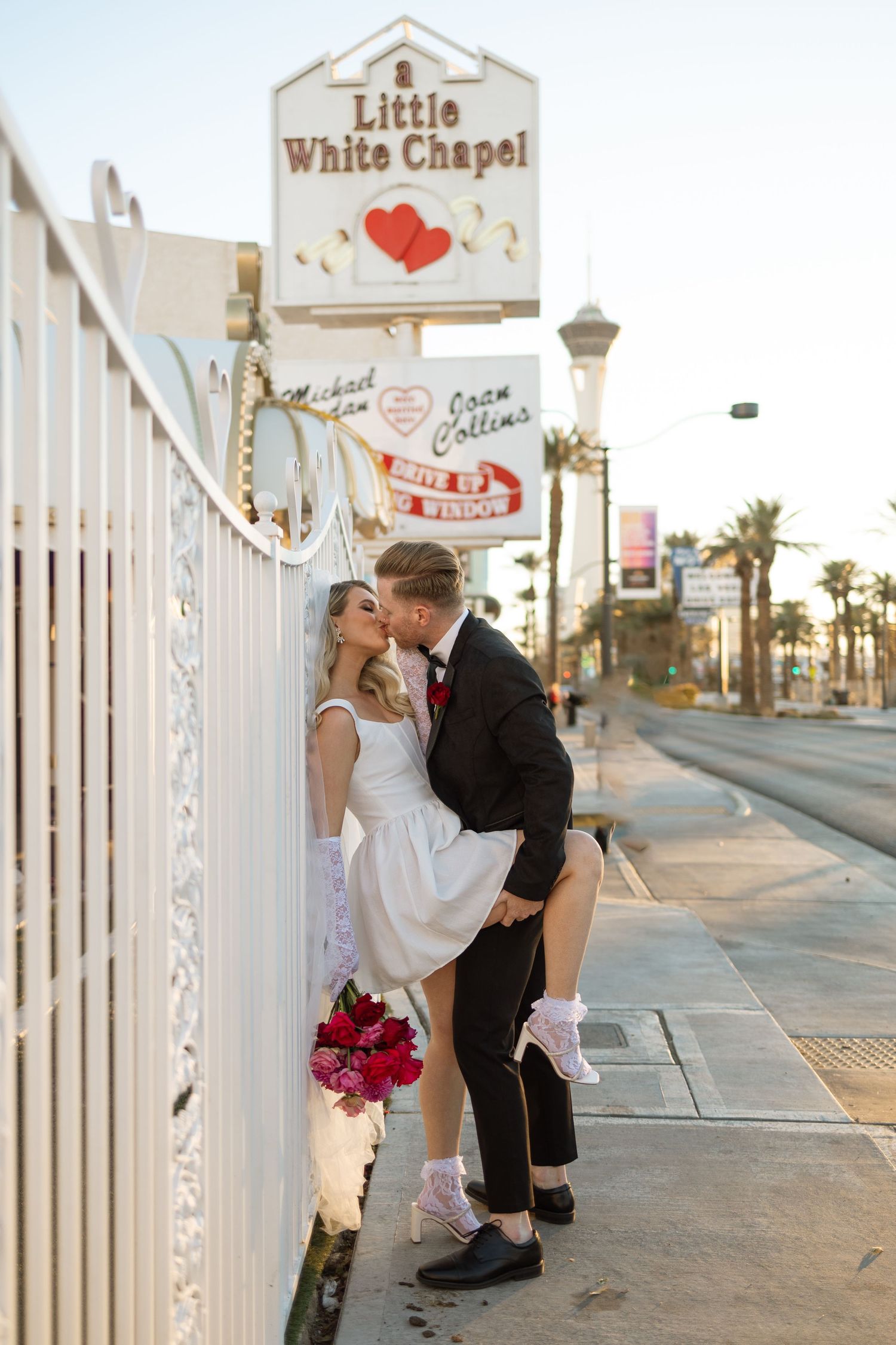 A flirty wedding photo captured outside the iconic Las Vegas Little White Chapel.