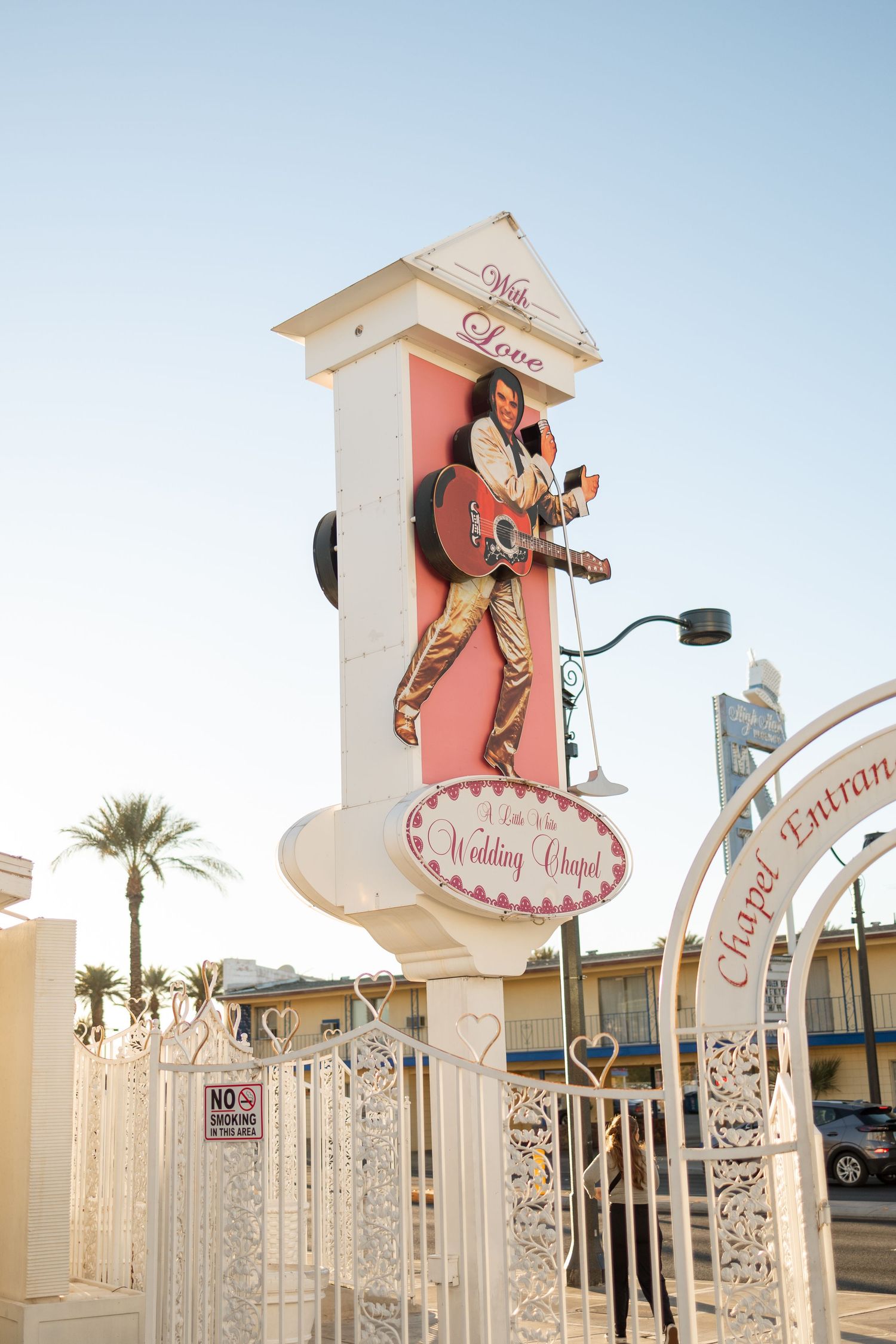 Retro Elvis-themed wedding chapel sign in Las Vegas with pink and white decor.