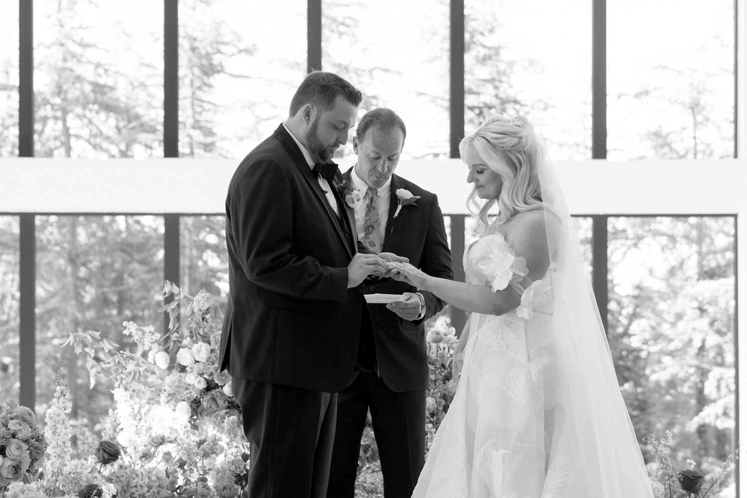 Black and white wedding ceremony photos showing intimate moments in an elegant indoor venue.