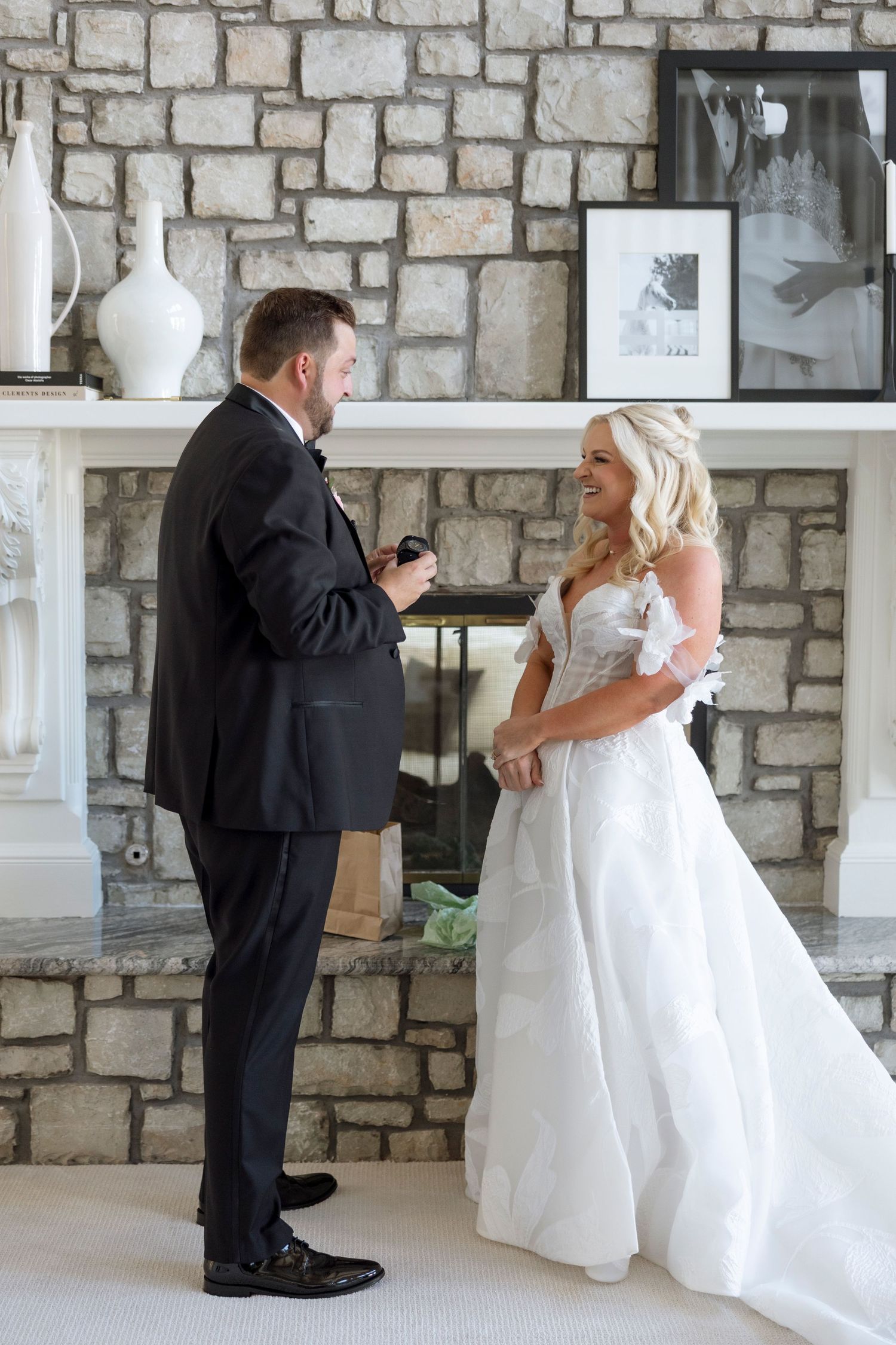 A series of first look moments between wedding couple against rustic stone wall.